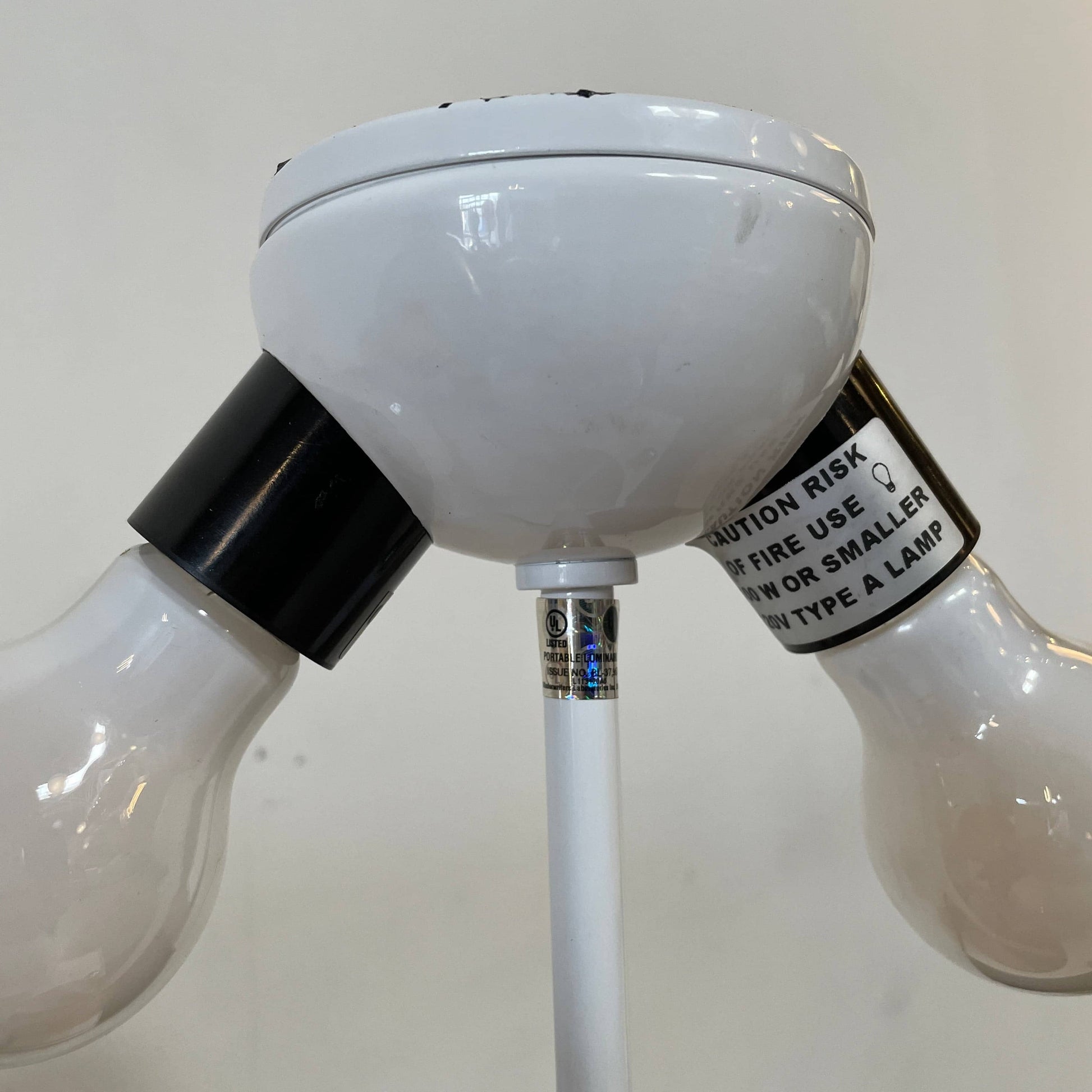 A minimalist Oluce Atolla Metal Table Lamp with a timeless design, showcased on a clean white background.