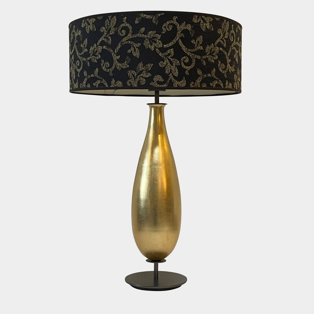 The Penta Gold Leaf Table Lamp by Penta is a glamorous reinvention of a classic with its gold and black design. It features a black shade, adding an elegant touch to any space.