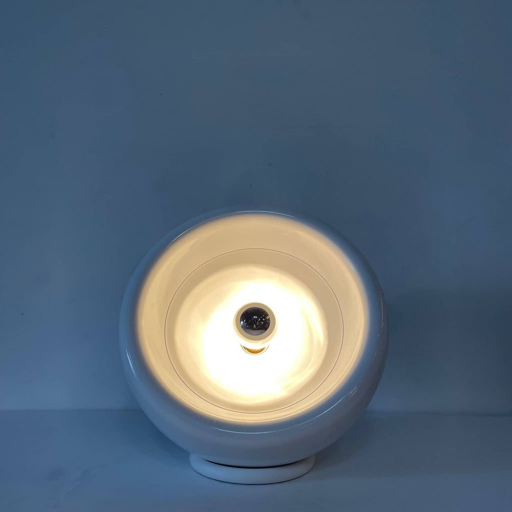A Yamagiwa Wan Table Light with a grey shade and a white cord.