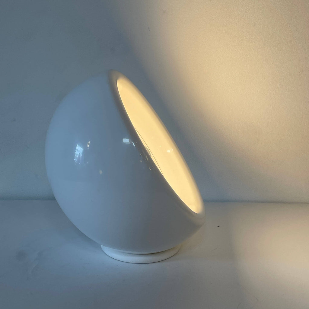 A Yamagiwa Wan Table Light with a grey shade and a white cord.