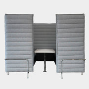 A set of comfortable and modular Vitra Alcove Cabin chairs with a table in the middle.