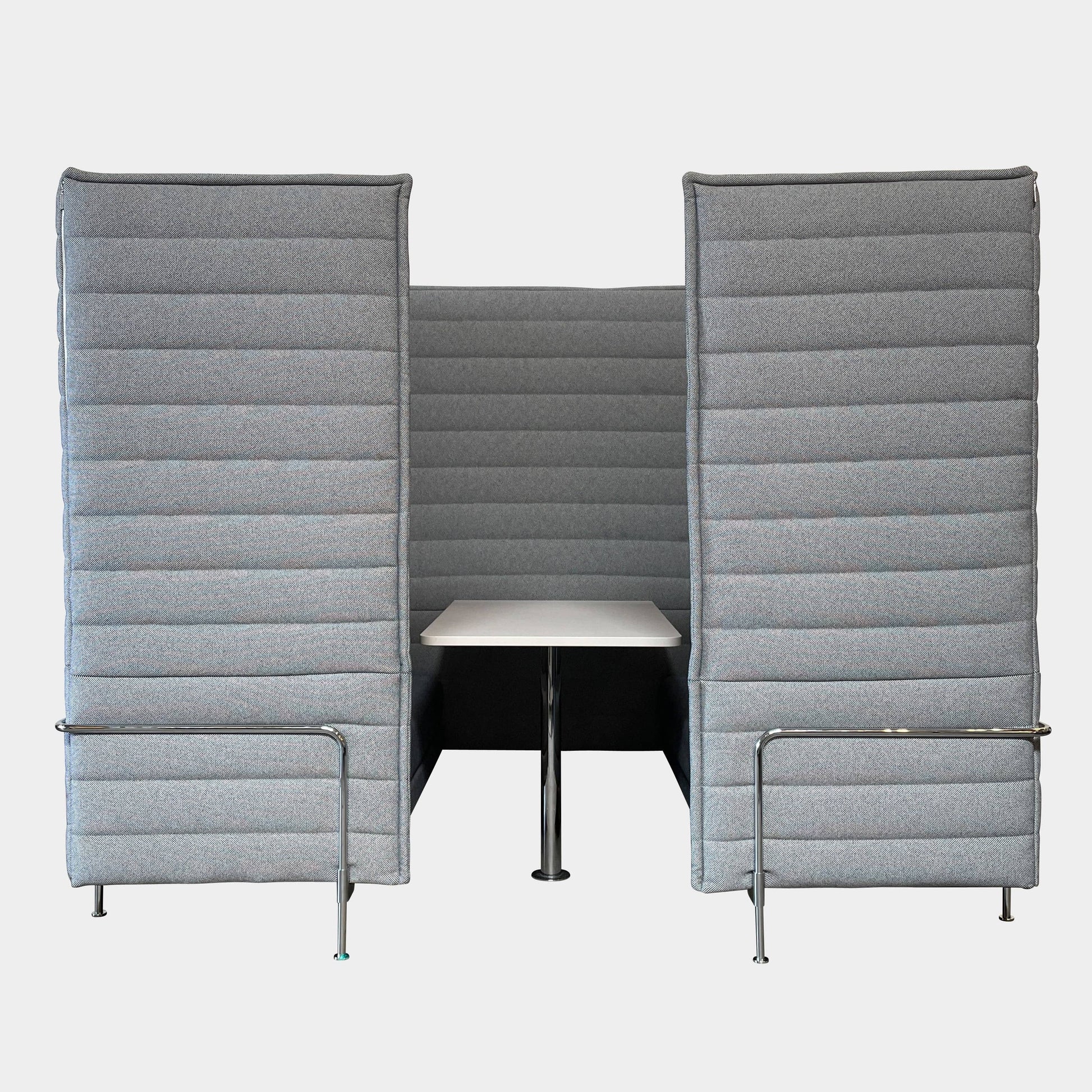 A set of comfortable and modular Vitra Alcove Cabin chairs with a table in the middle.