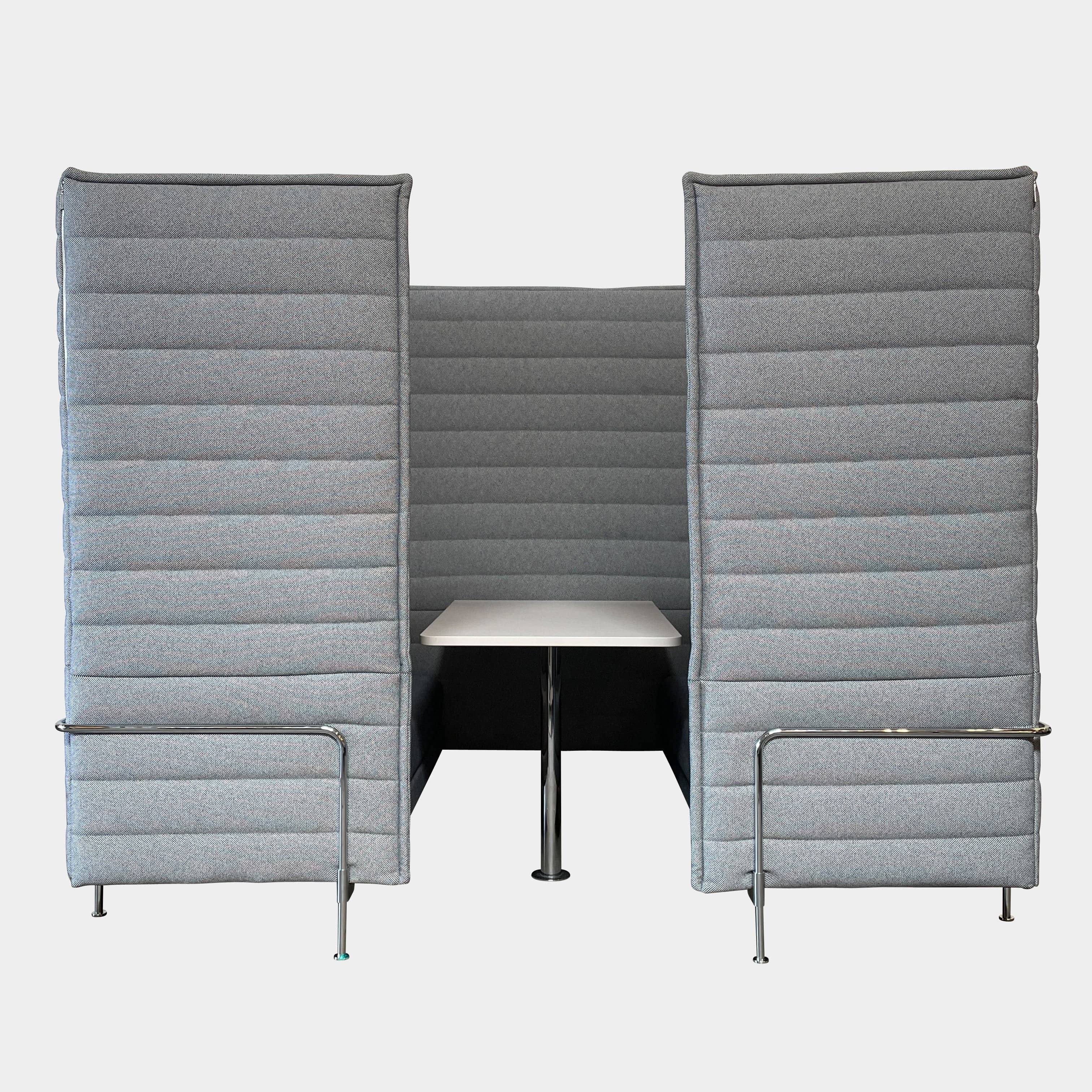 A set of comfortable and modular Vitra Alcove Cabin chairs with a table in the middle.