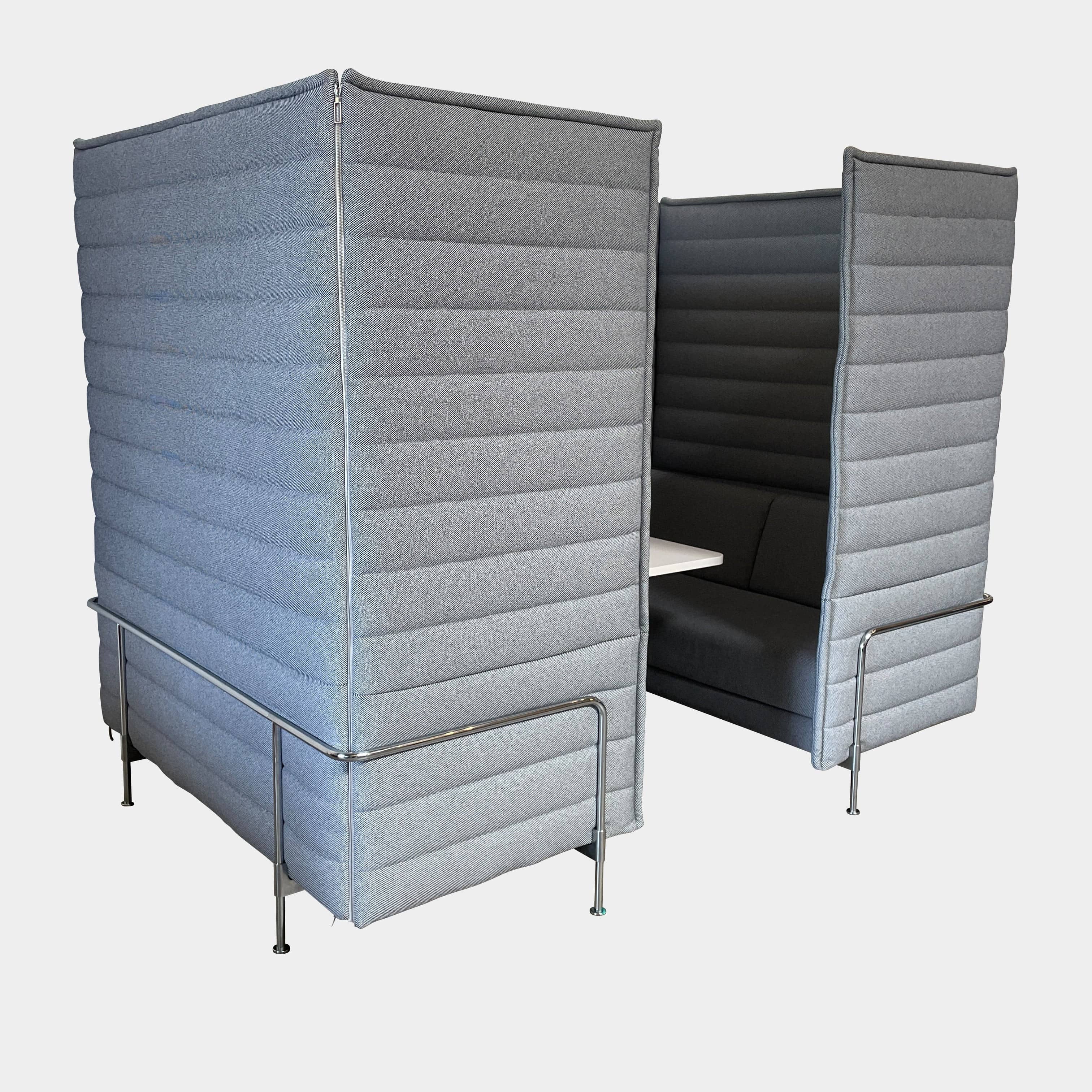 A set of comfortable and modular Vitra Alcove Cabin chairs with a table in the middle.