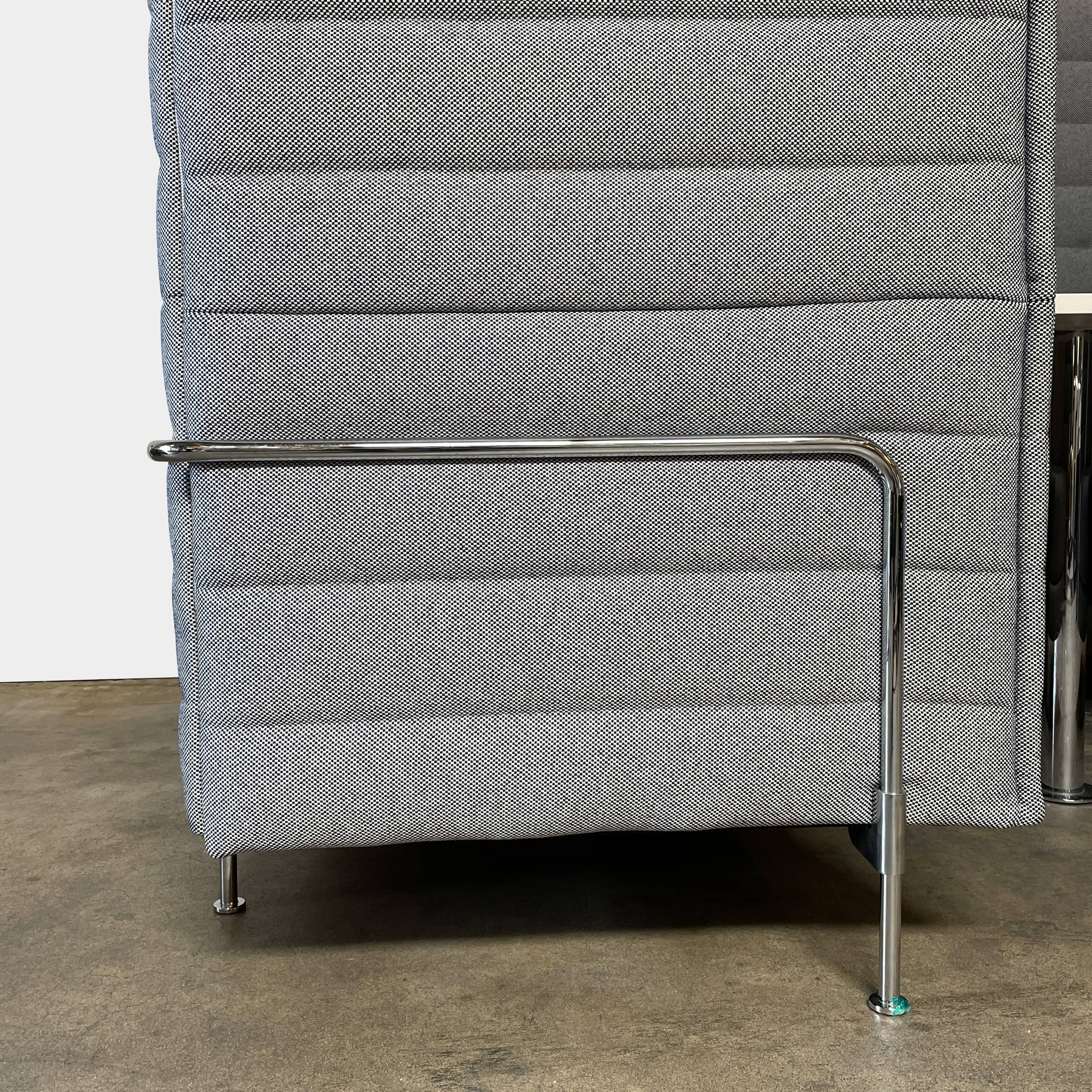 A set of comfortable and modular Vitra Alcove Cabin chairs with a table in the middle.