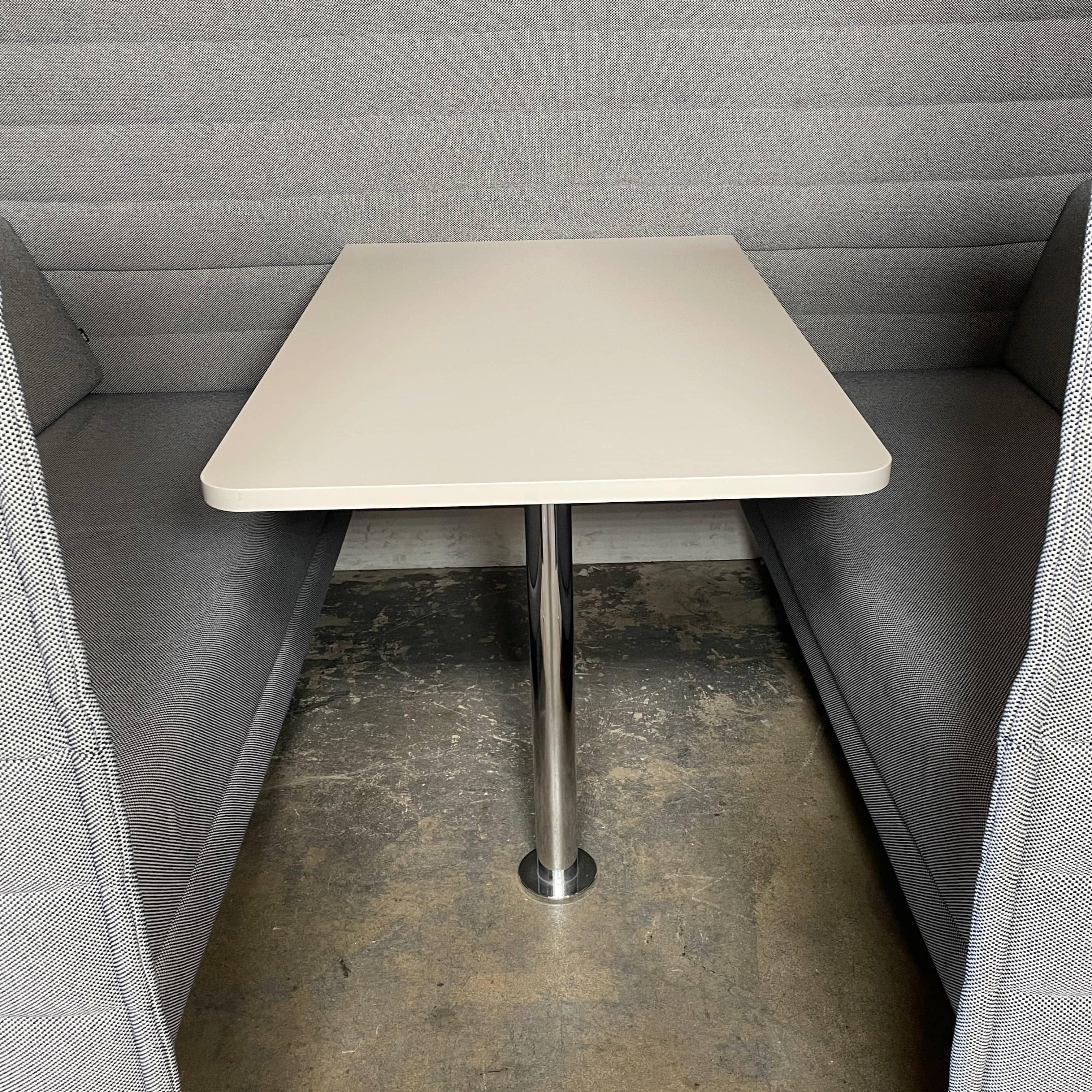 A set of comfortable and modular Vitra Alcove Cabin chairs with a table in the middle.