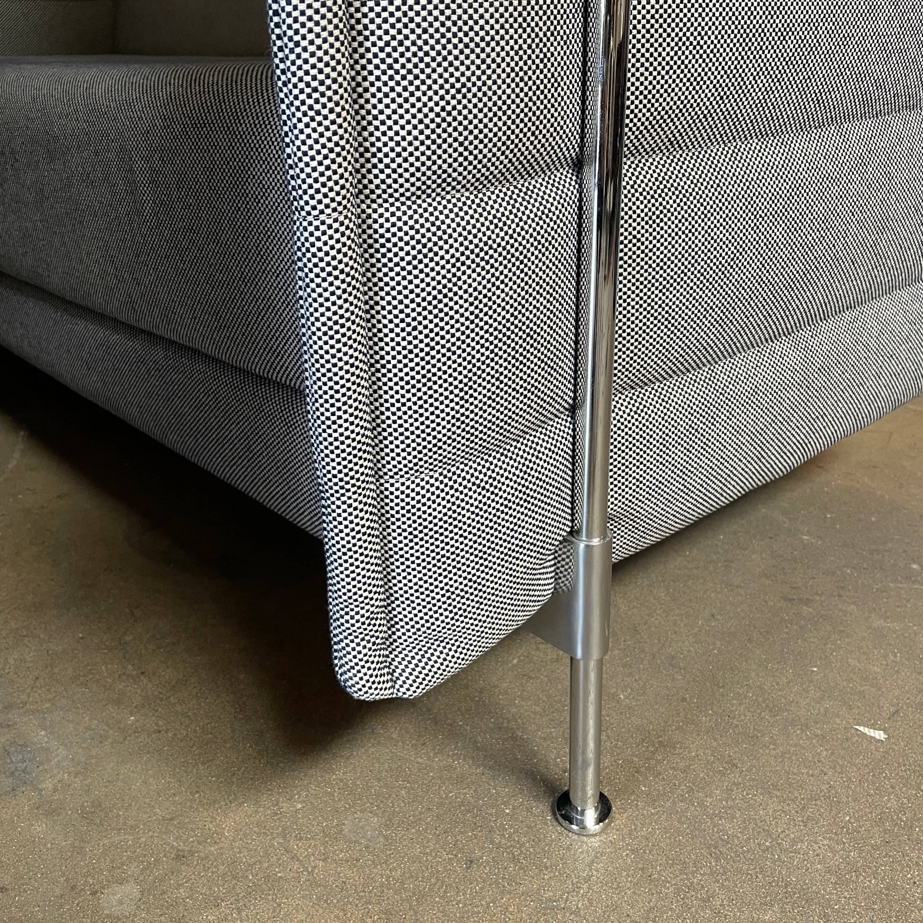 A set of comfortable and modular Vitra Alcove Cabin chairs with a table in the middle.