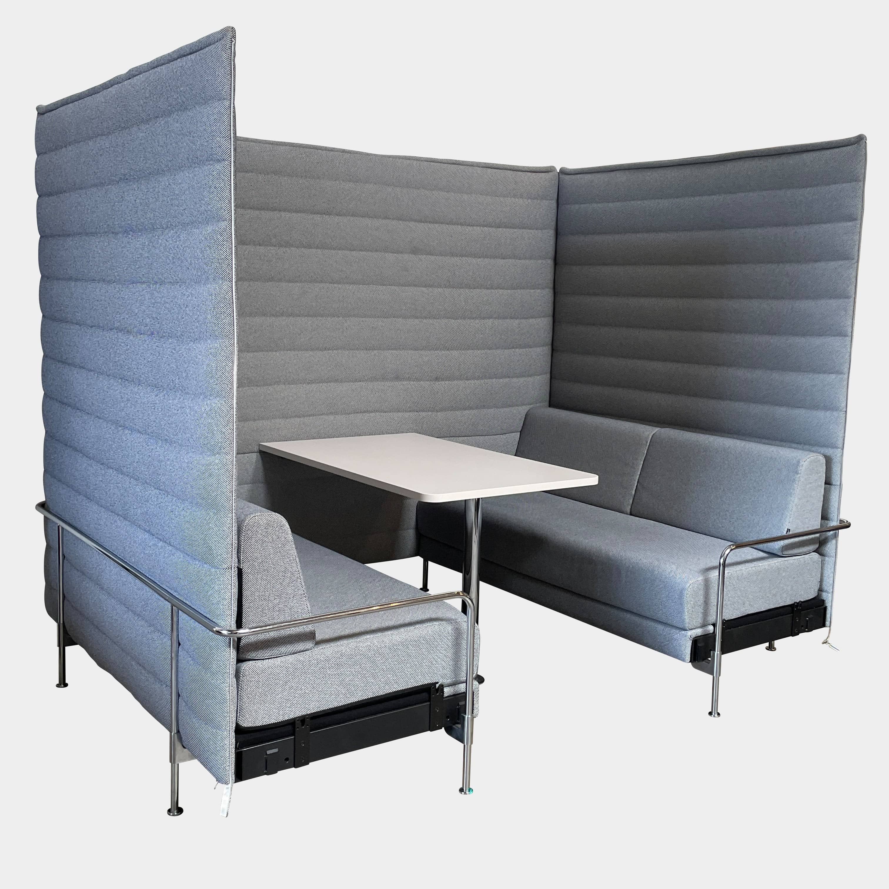 A set of comfortable and modular Vitra Alcove Cabin chairs with a table in the middle.