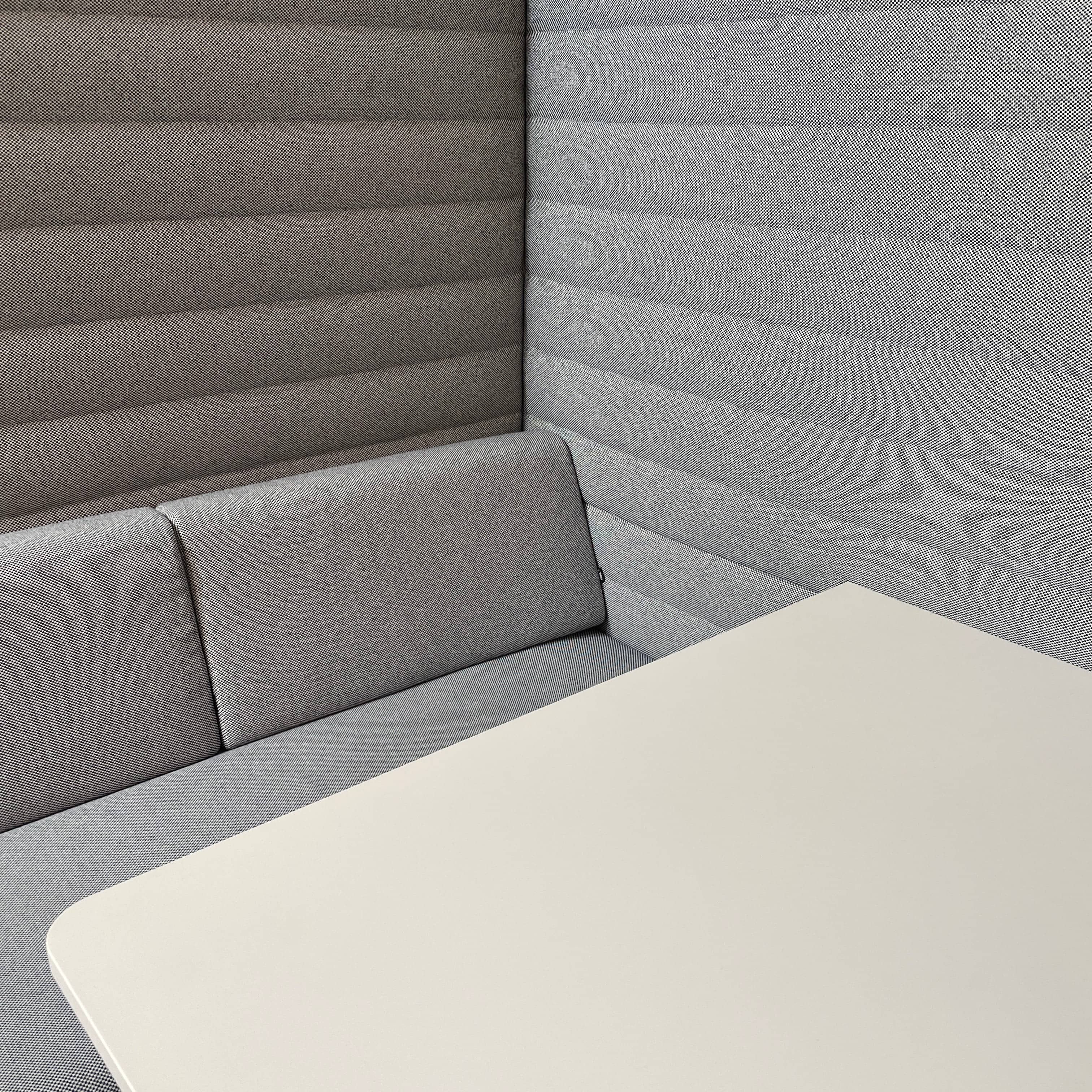 A set of comfortable and modular Vitra Alcove Cabin chairs with a table in the middle.