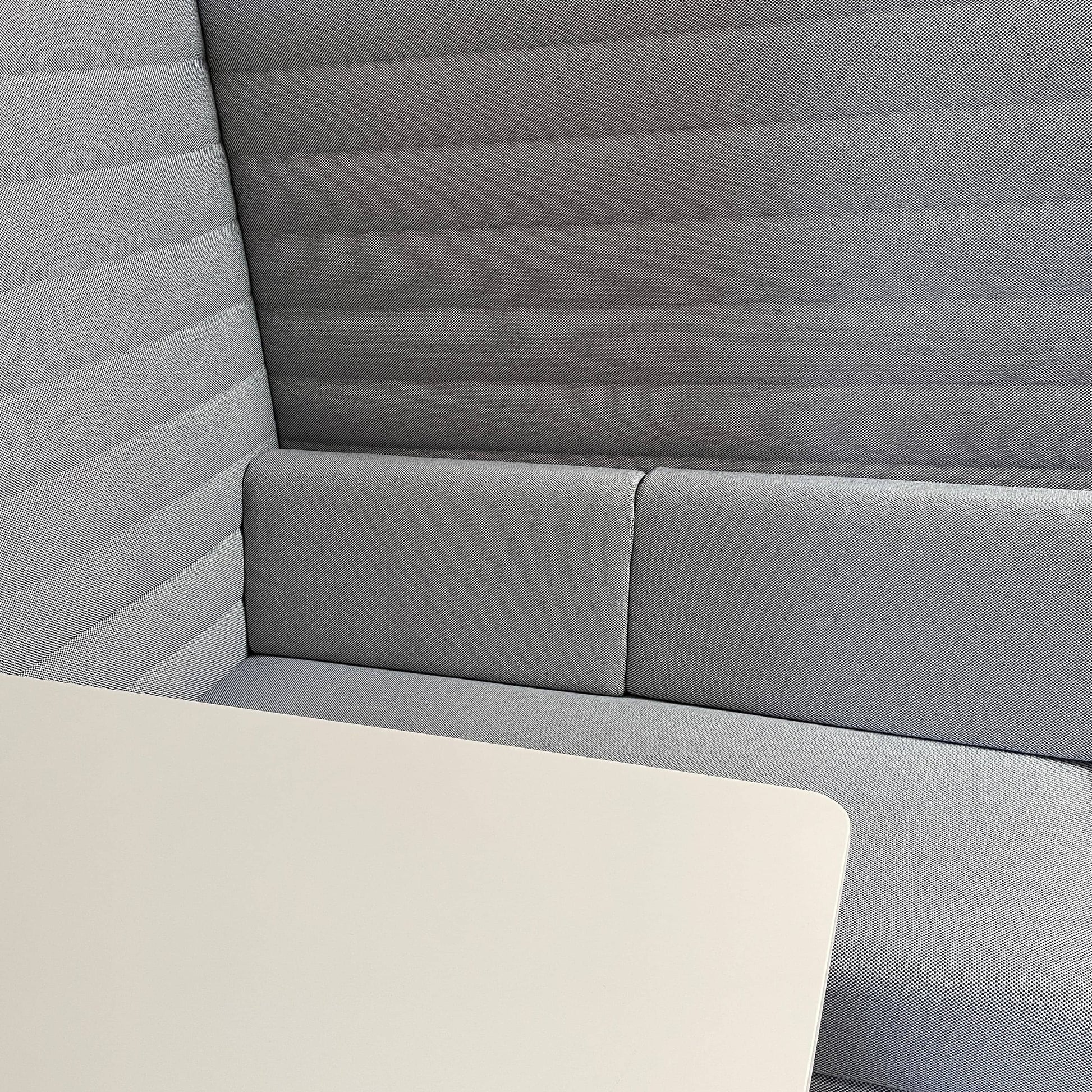 A set of comfortable and modular Vitra Alcove Cabin chairs with a table in the middle.