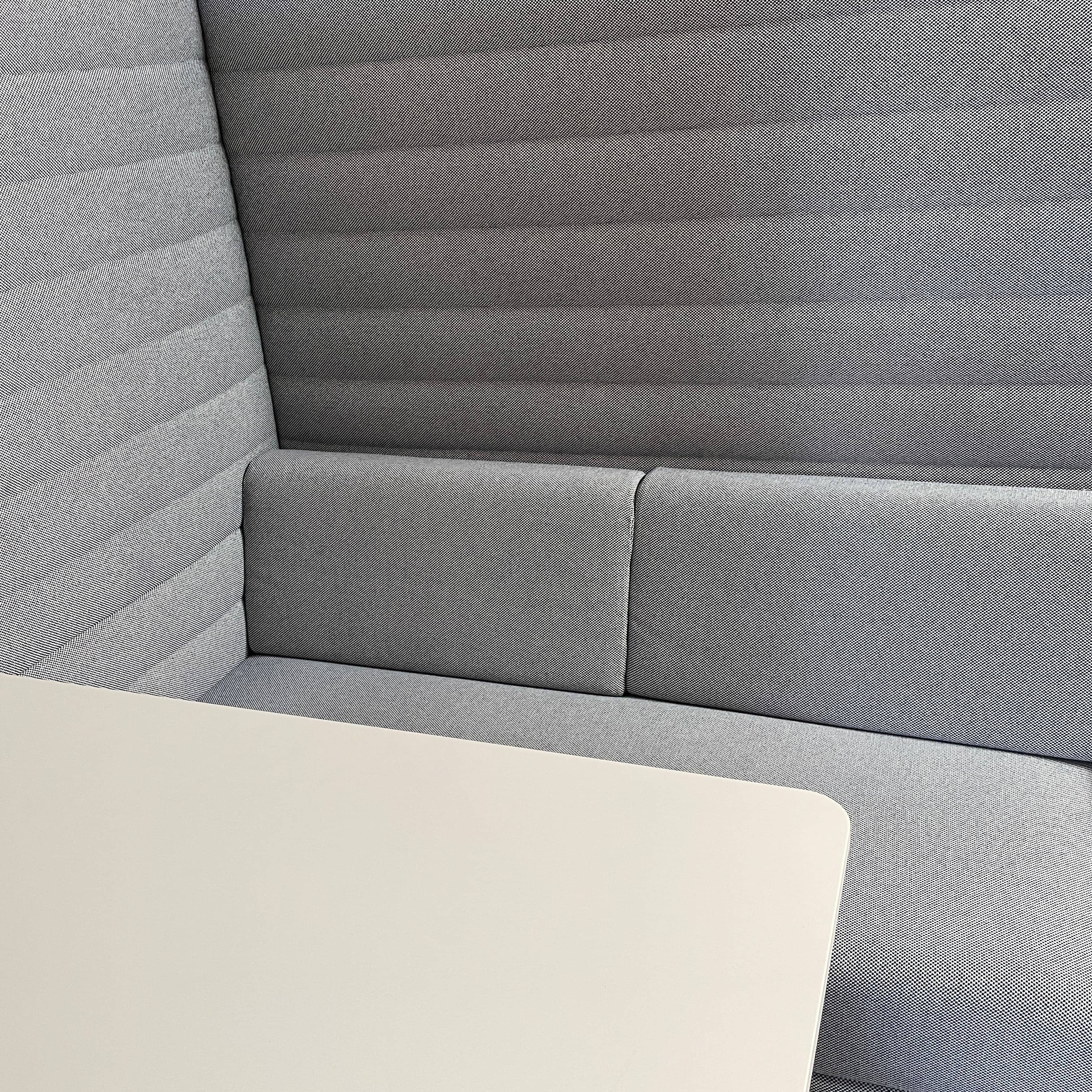 A set of comfortable and modular Vitra Alcove Cabin chairs with a table in the middle.