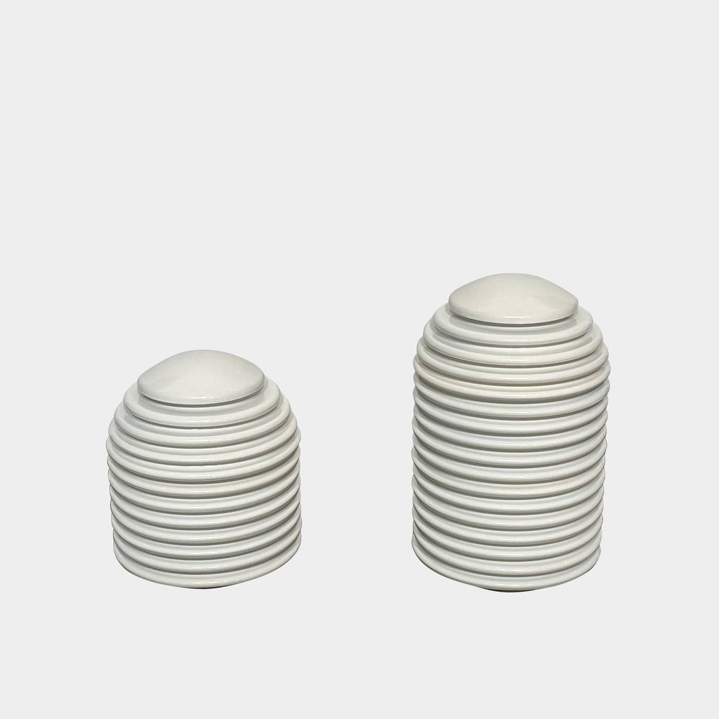 A pair of Yamagiwa Aureola Table Lights with a contemporary touch on a white surface.