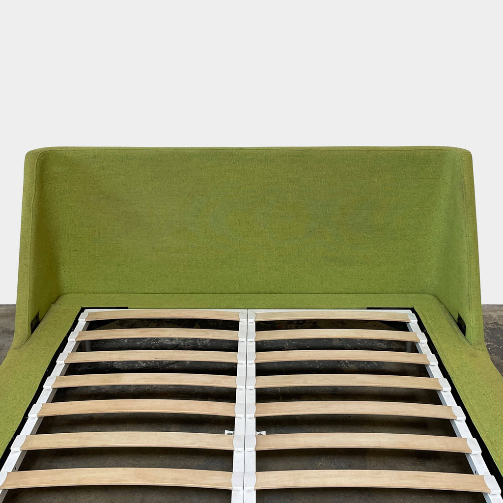 A contemporary Blu Dot Nook Queen Size Bed frame with a wooden slatted base in a green color enhanced by Blu Dot's innovative design.