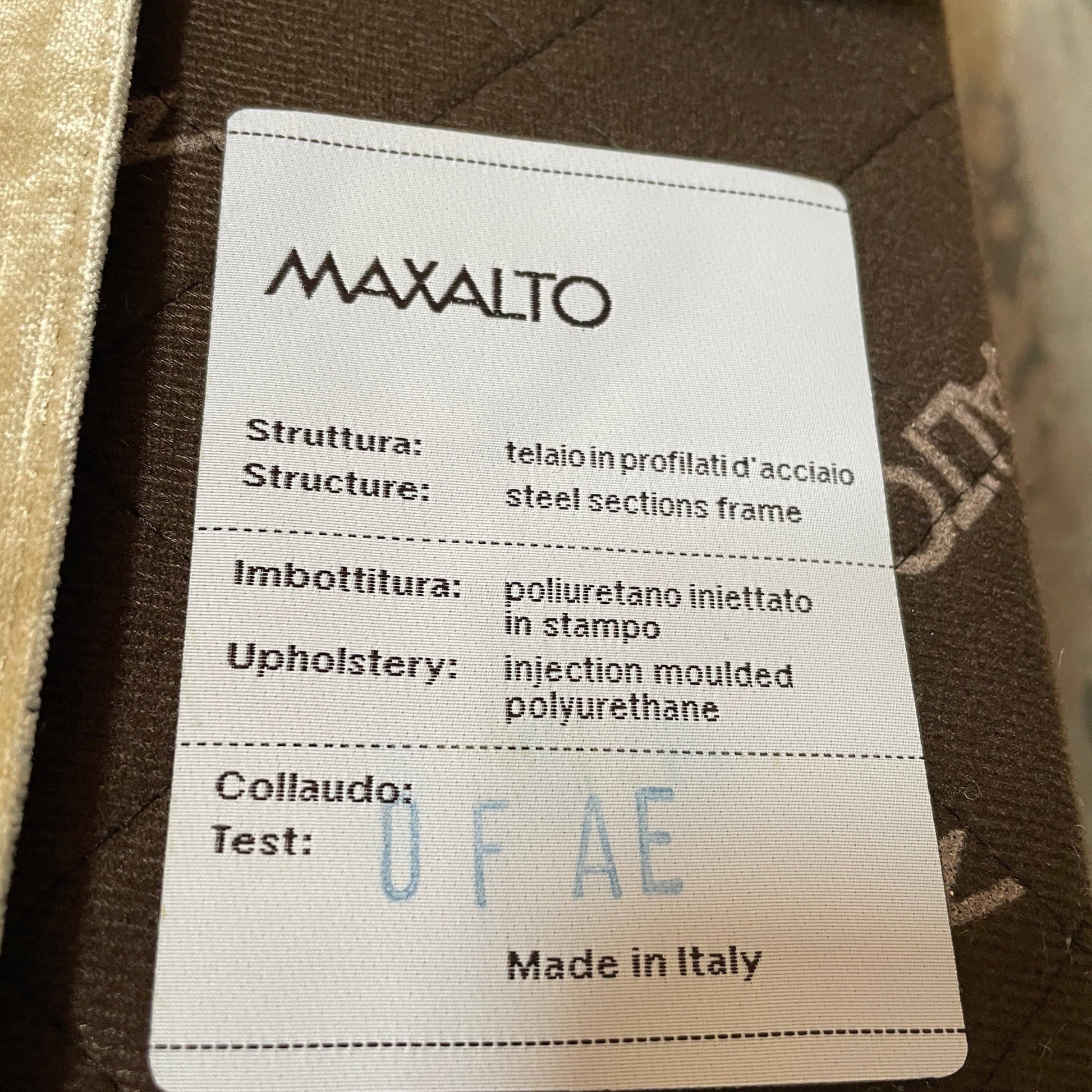 The Maxalto Febo Queen Bed is an upholstered bed frame featuring a headboard and two pillows, all elegantly wrapped in champagne-colored velvet. The frame boasts wooden slats for support, providing the refined touch of a luxury hotel bed. Shown without a mattress.