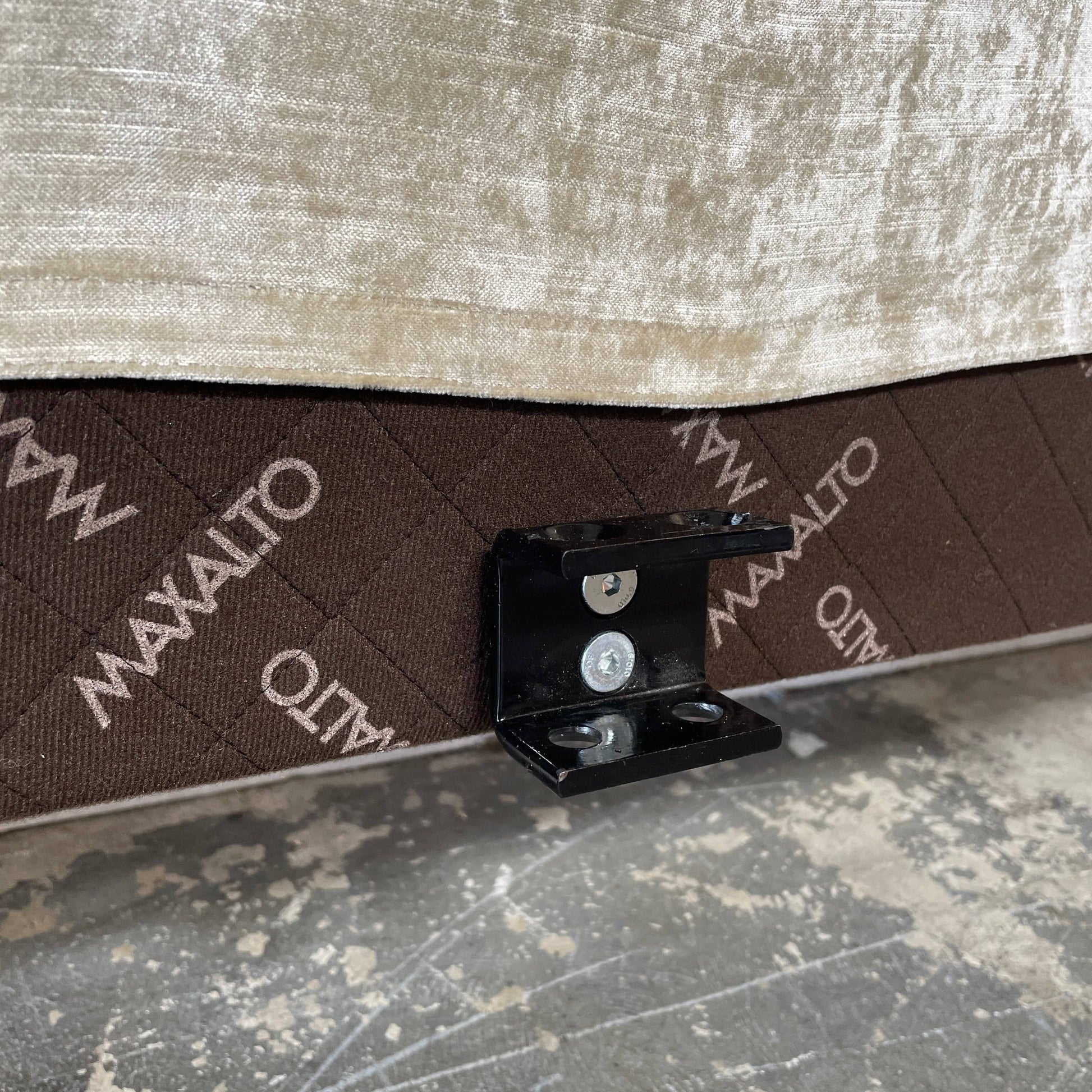 The Maxalto Febo Queen Bed is an upholstered bed frame featuring a headboard and two pillows, all elegantly wrapped in champagne-colored velvet. The frame boasts wooden slats for support, providing the refined touch of a luxury hotel bed. Shown without a mattress.