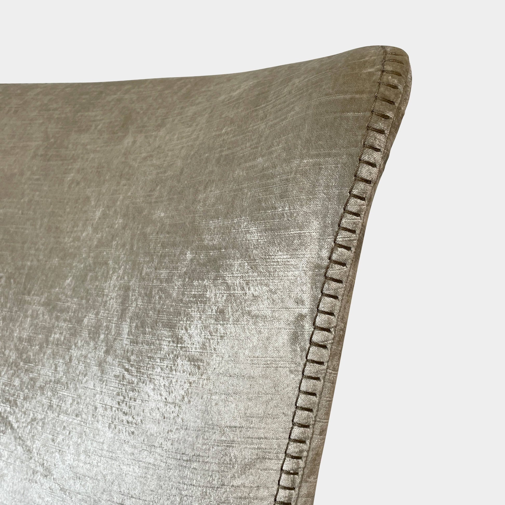 The Maxalto Febo Queen Bed is an upholstered bed frame featuring a headboard and two pillows, all elegantly wrapped in champagne-colored velvet. The frame boasts wooden slats for support, providing the refined touch of a luxury hotel bed. Shown without a mattress.