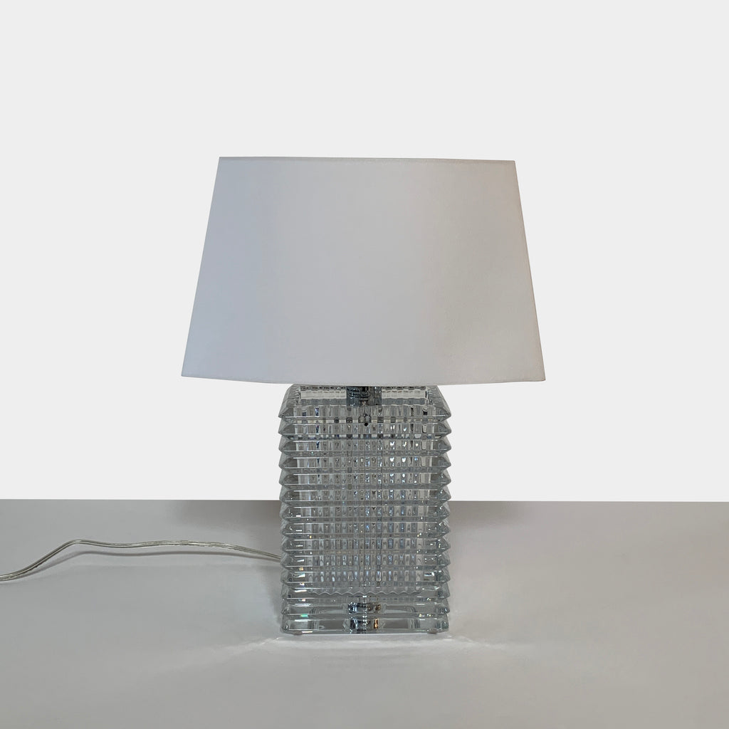 A Baccarat Eye Table Lamp with a white shade.