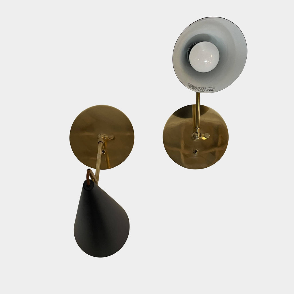 The Visual Comfort Clemente Sconce Set is an elegant wall lamp featuring a stylish combination of black and gold accents. Its white shade adds a touch of sophistication to any room. The lamp showcases an