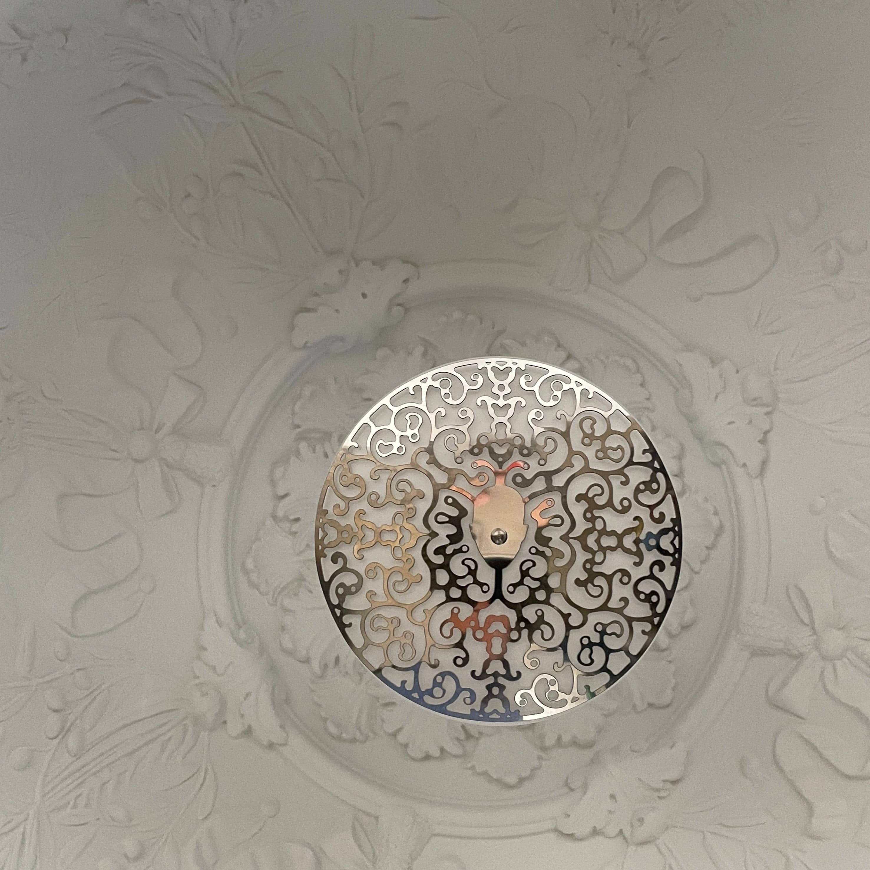 An ornate Flos Skygarden Suspension Light: Matte Rusty Brown pendant light with an interior shade.