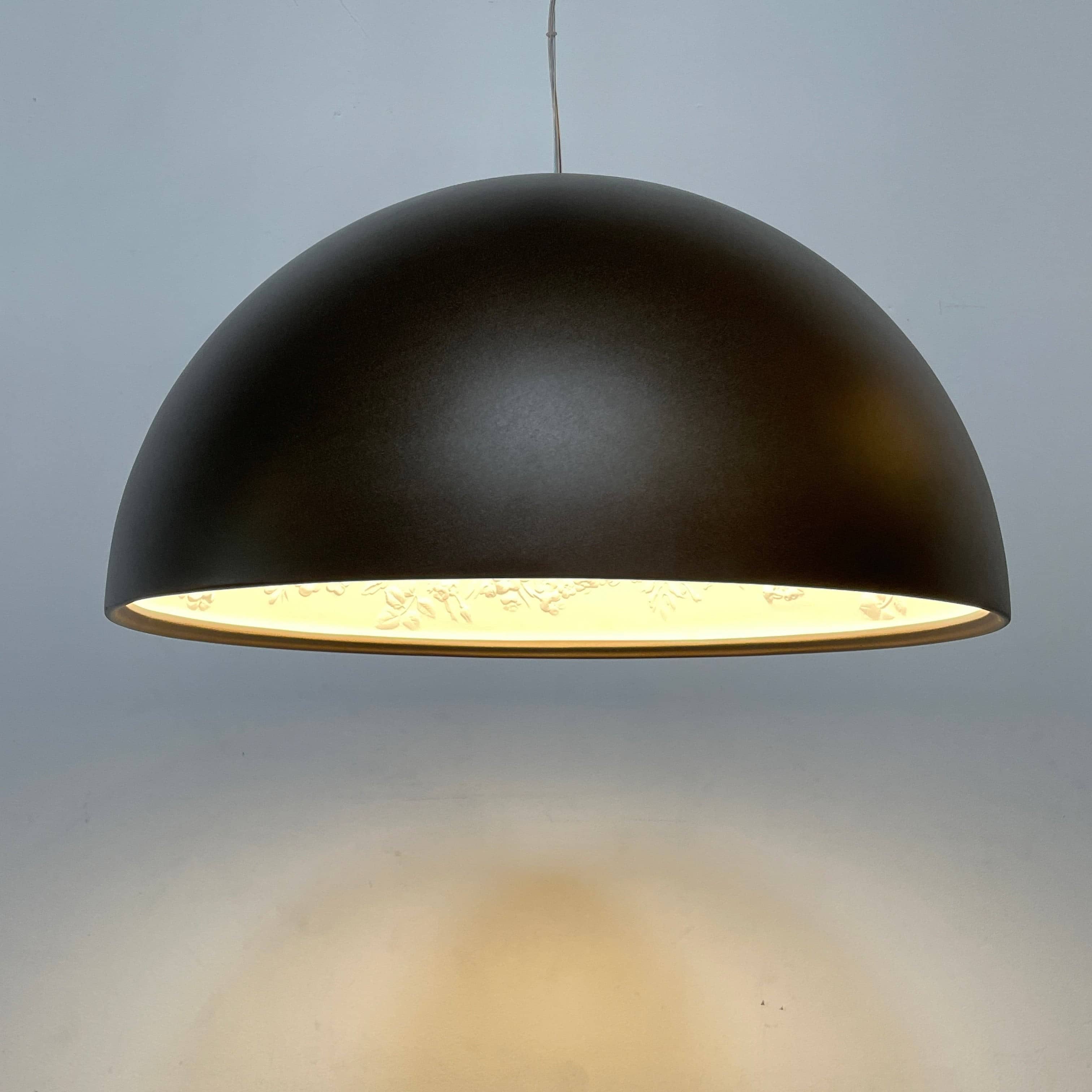 An ornate Flos Skygarden Suspension Light: Matte Rusty Brown pendant light with an interior shade.