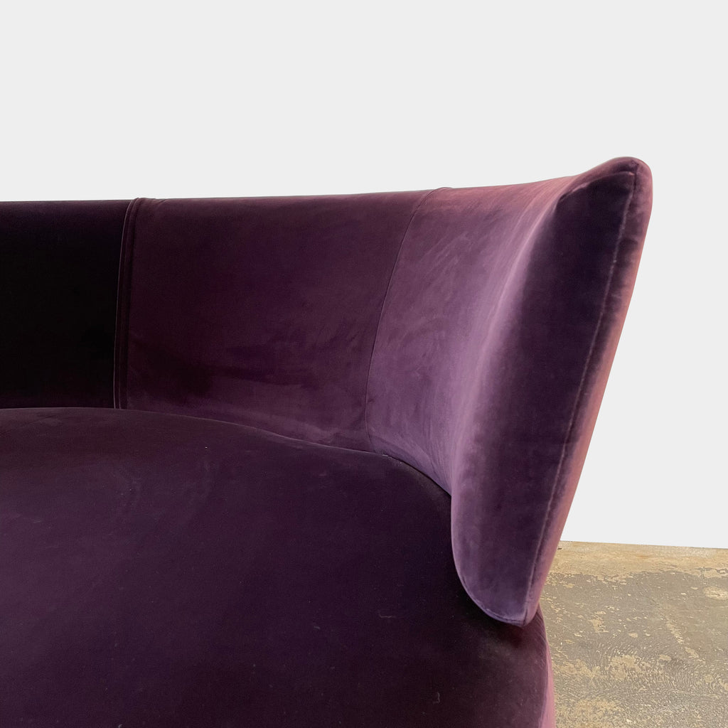 A Maxalto Amoenus Circular Swivel Sofa with pillows in a cozy and luxurious design.