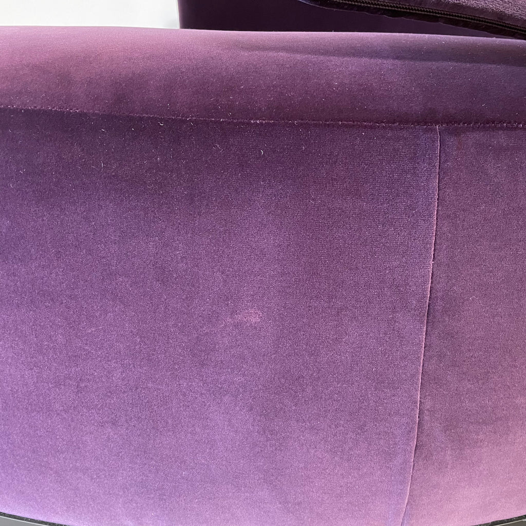 A Maxalto Amoenus Circular Swivel Sofa with pillows in a cozy and luxurious design.