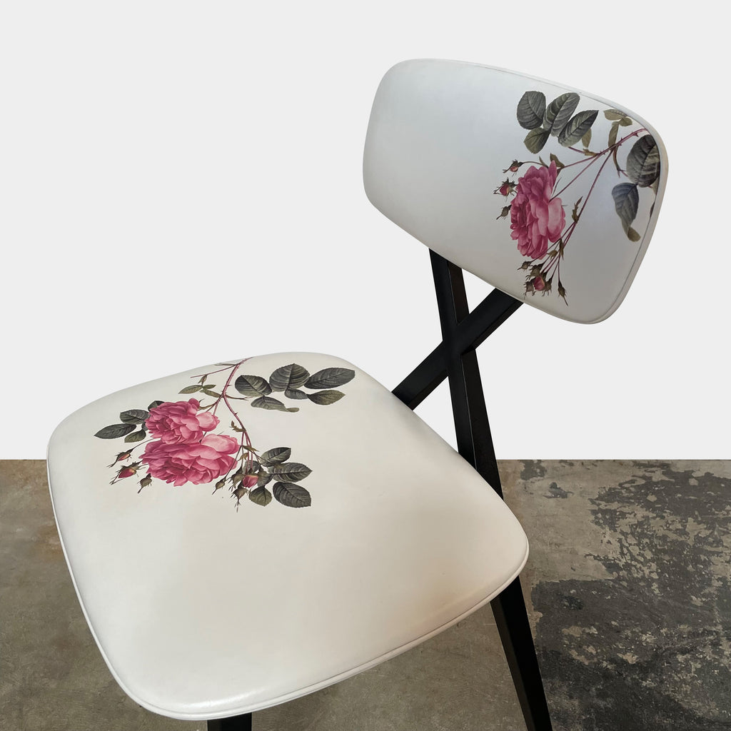 A set of six Qeeboo Chair X dining chairs with a floral pattern.