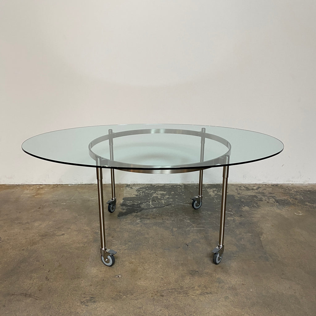 The Driade Ito Dining Table from Driade offers adaptability with its mobile design on wheels, making it easy to move around. It features a chrome base for a sleek and modern look.