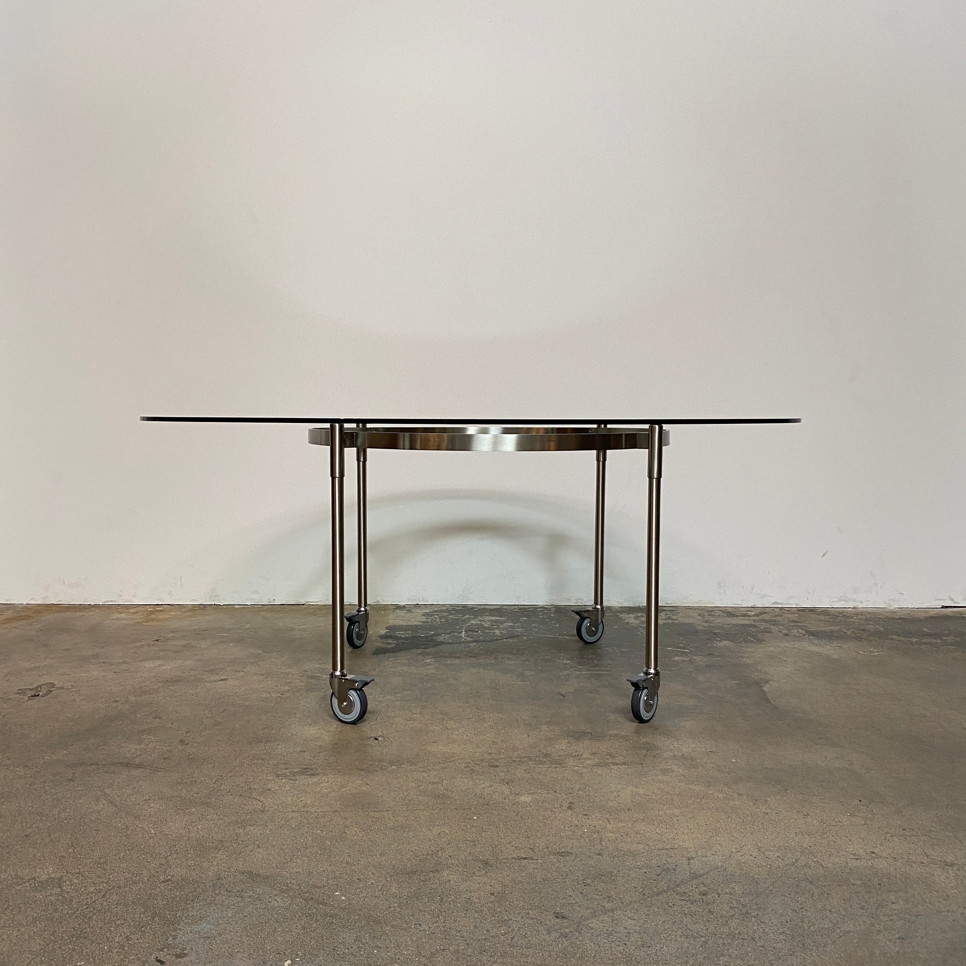 The Driade Ito Dining Table from Driade offers adaptability with its mobile design on wheels, making it easy to move around. It features a chrome base for a sleek and modern look.