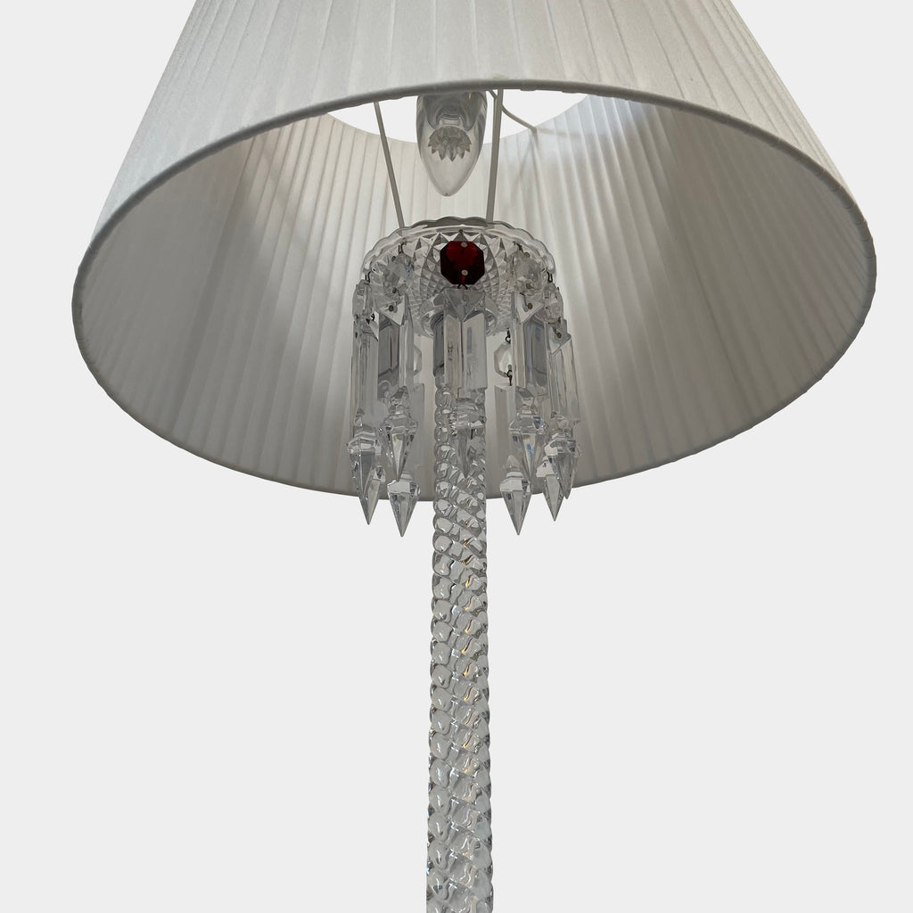 A Baccarat Torch Ceiling Lamp with a red tassel hanging from it.