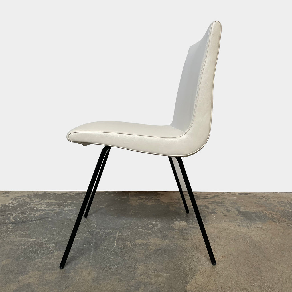 Two white Ligne Roset TV chairs with black legs on a white background.