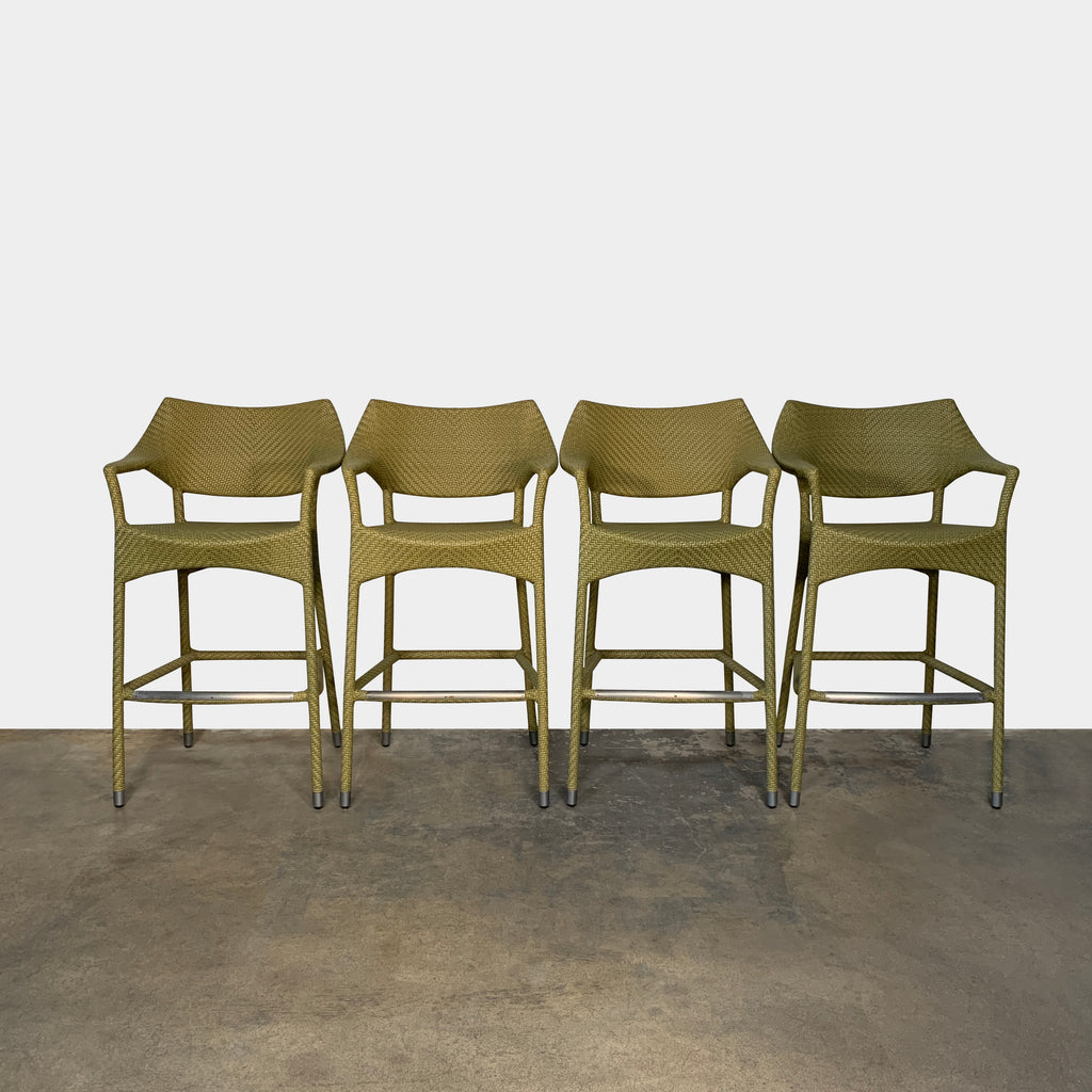 A Janus et Cie Amari Outdoor Bar Height Stool Set, made of green rattan, is showcased against a white background.