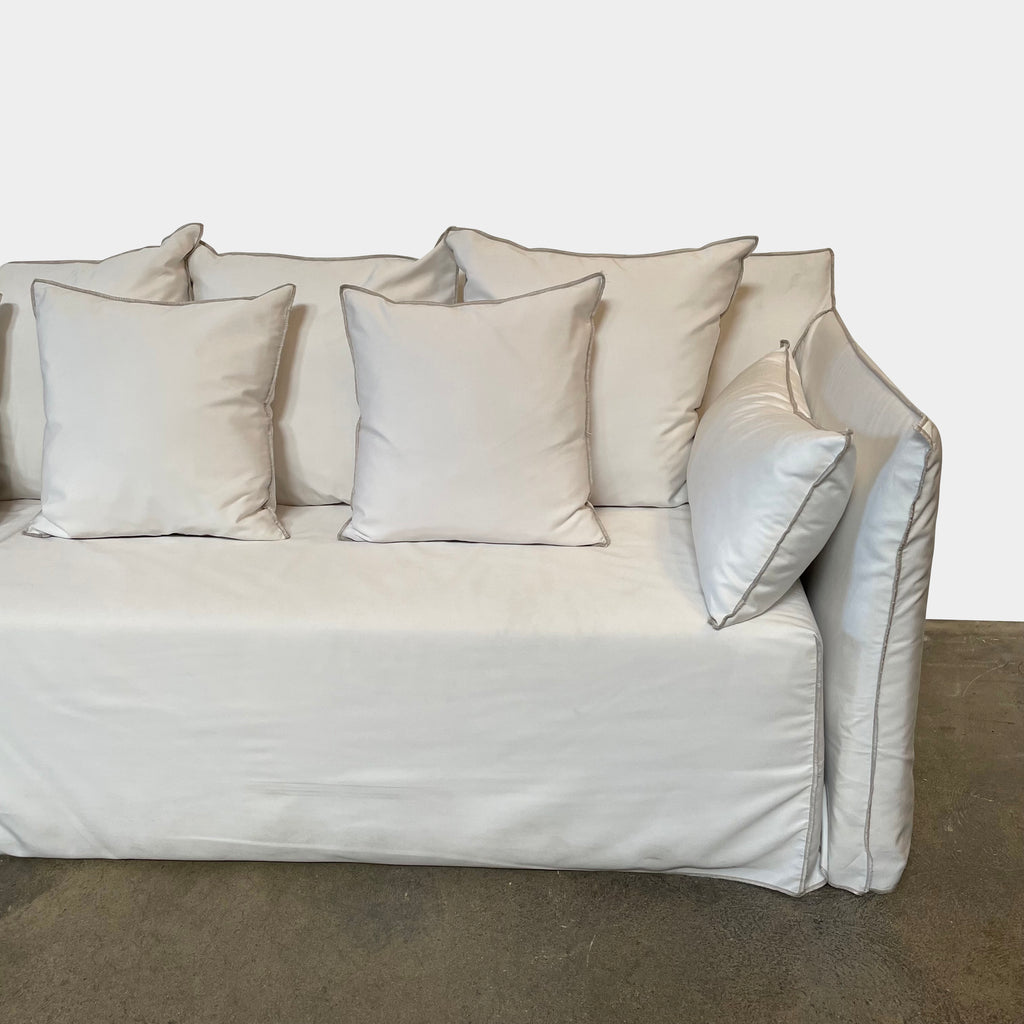 A Gervasoni Ghost Out Outdoor Sofa with several pillows on it.
