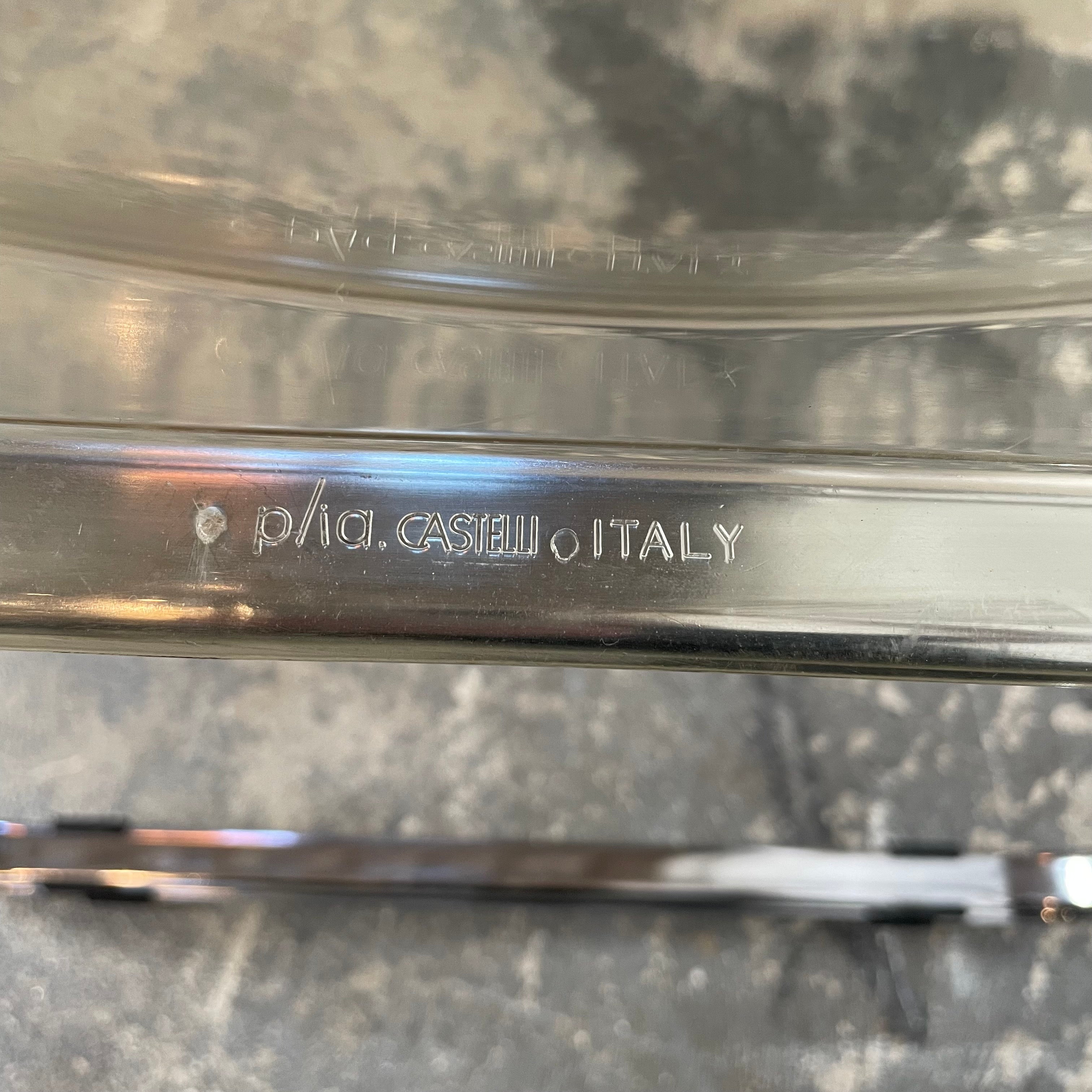 The Anonima Castelli Plia Folding Chair by Castelli, highlighted against a plain white background, echoes the iconic design of Giancarlo Piretti's Plia Folding Chairs and features the innovative "3-disc pin" mechanism.