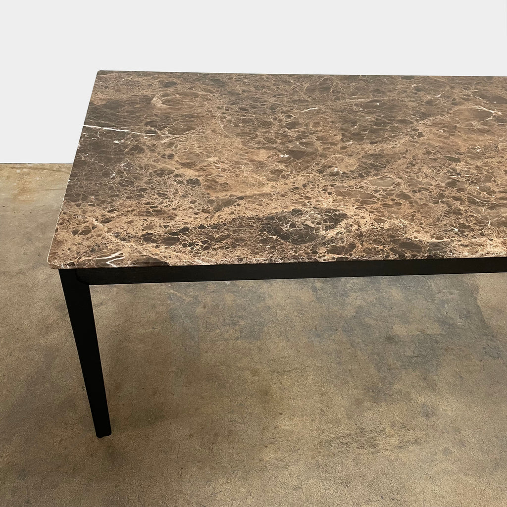 An Arflex Hug Marble Dining Table with black legs, offering clean lines and a modern statement piece.