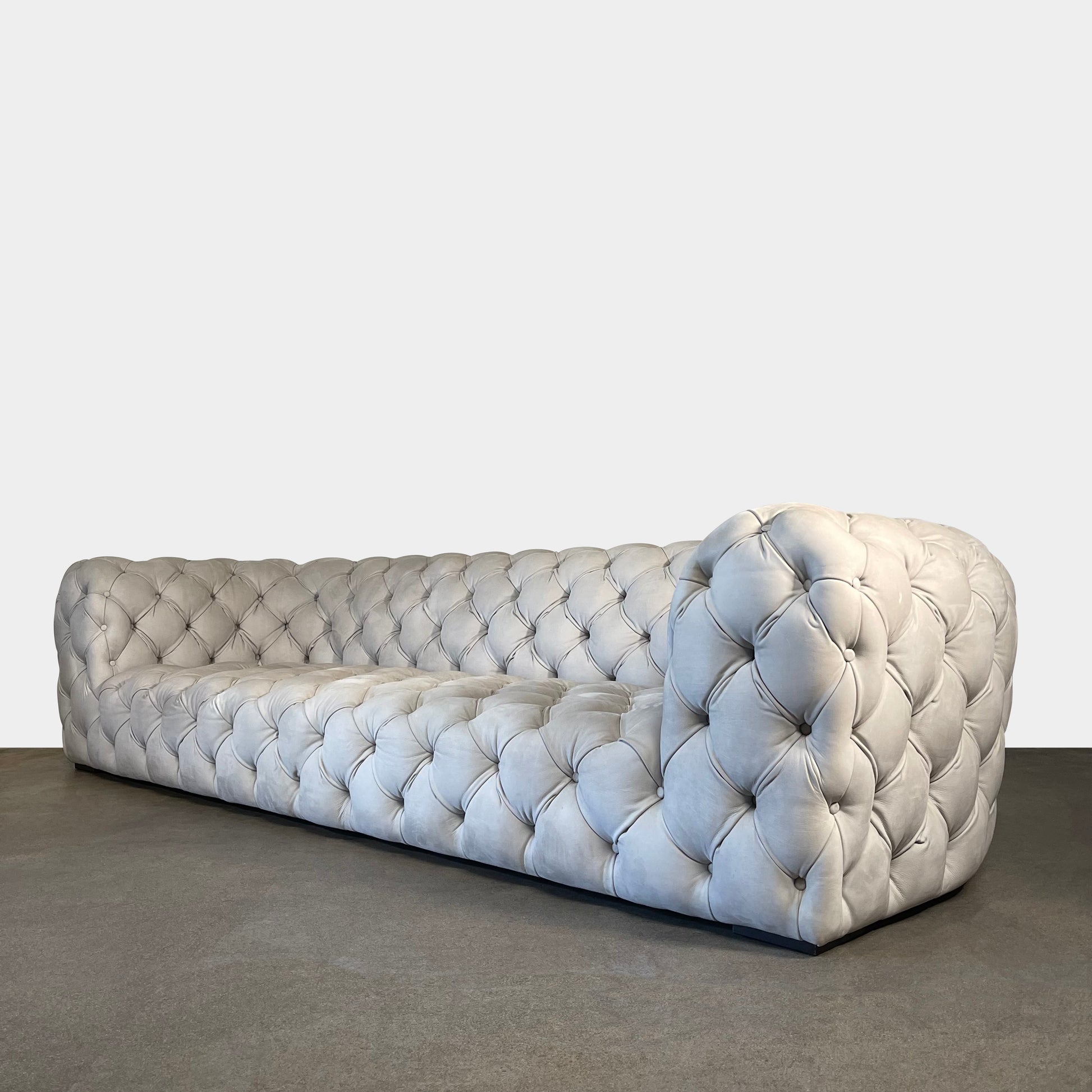 A white Baxter Chester Moon Sofa with a tufted back.