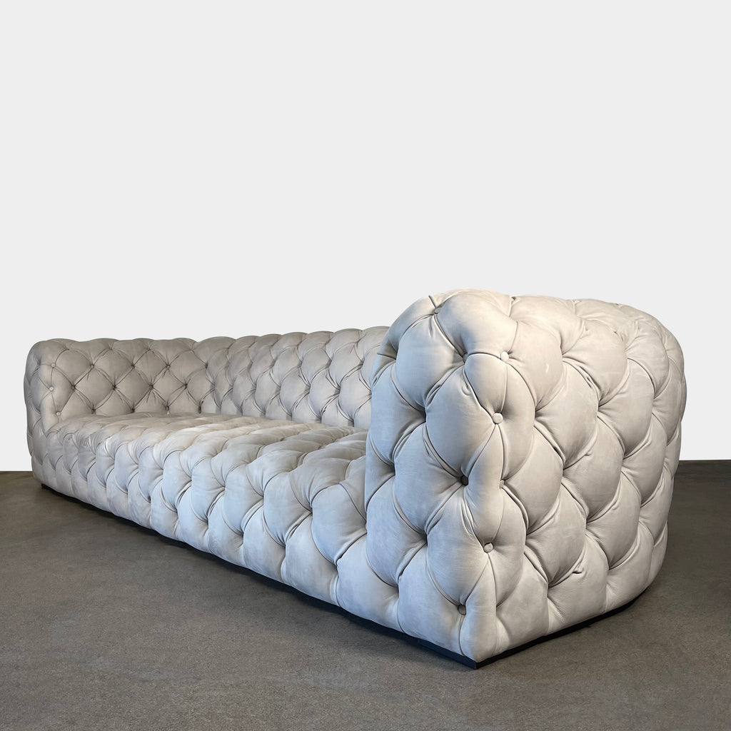 A white Baxter Chester Moon Sofa with a tufted back.