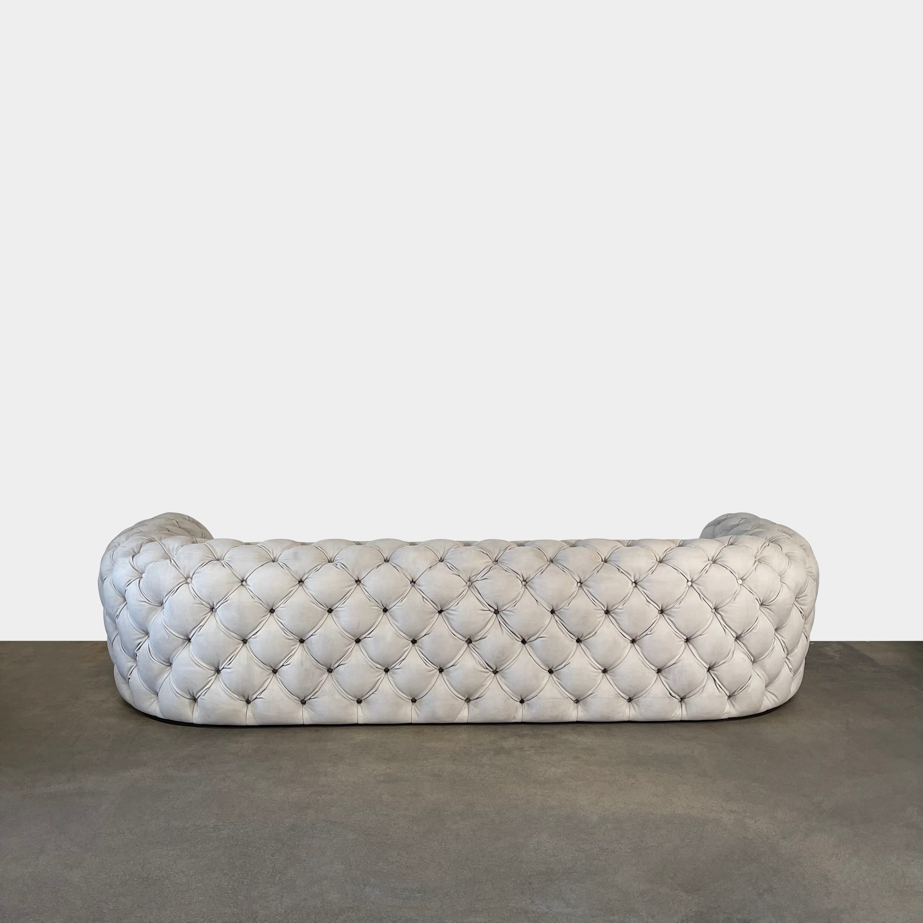 A white Baxter Chester Moon Sofa with a tufted back.