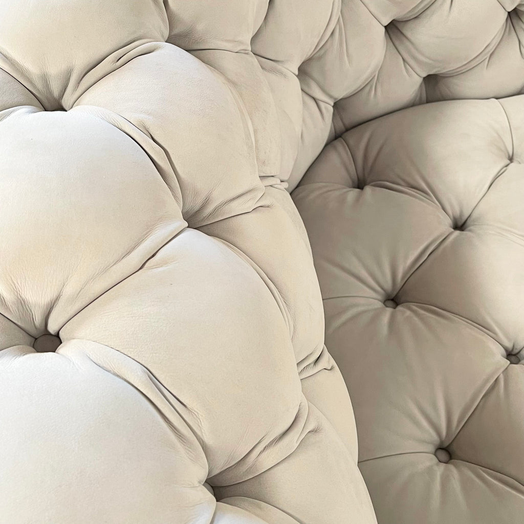 A white Baxter Chester Moon Sofa with a tufted back.