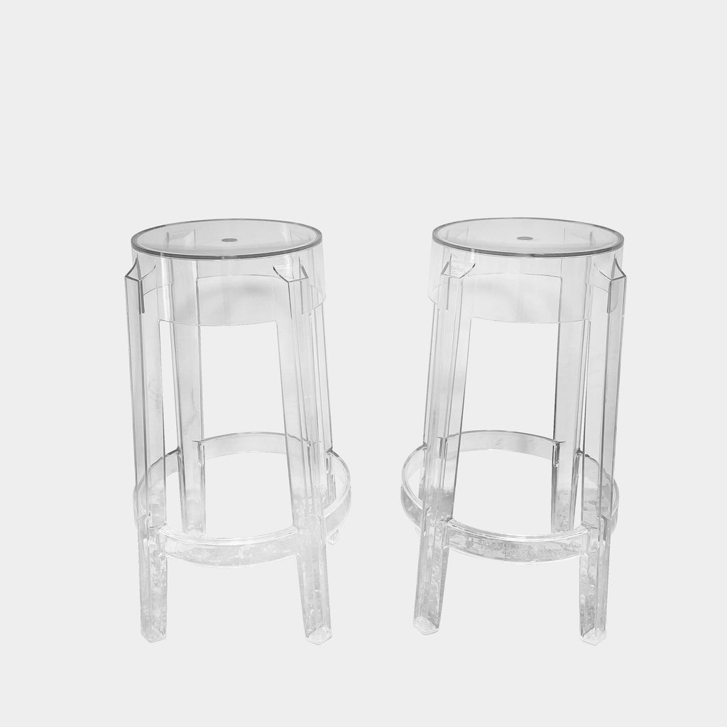 Two transparent Kartell Ghost Stackable Counter Height Stools on a white background.