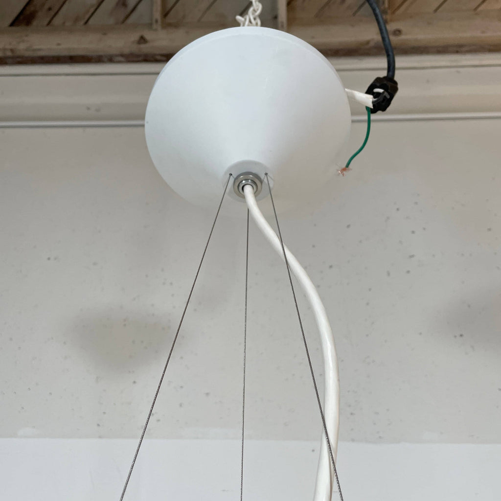 A Louis Poulsen PH Artichoke Suspension light with a white shade, providing glare-free light.