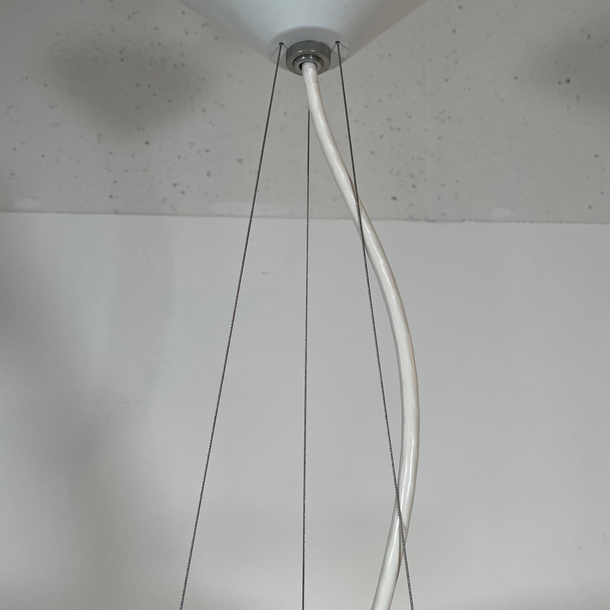 A Louis Poulsen PH Artichoke Suspension light with a white shade, providing glare-free light.