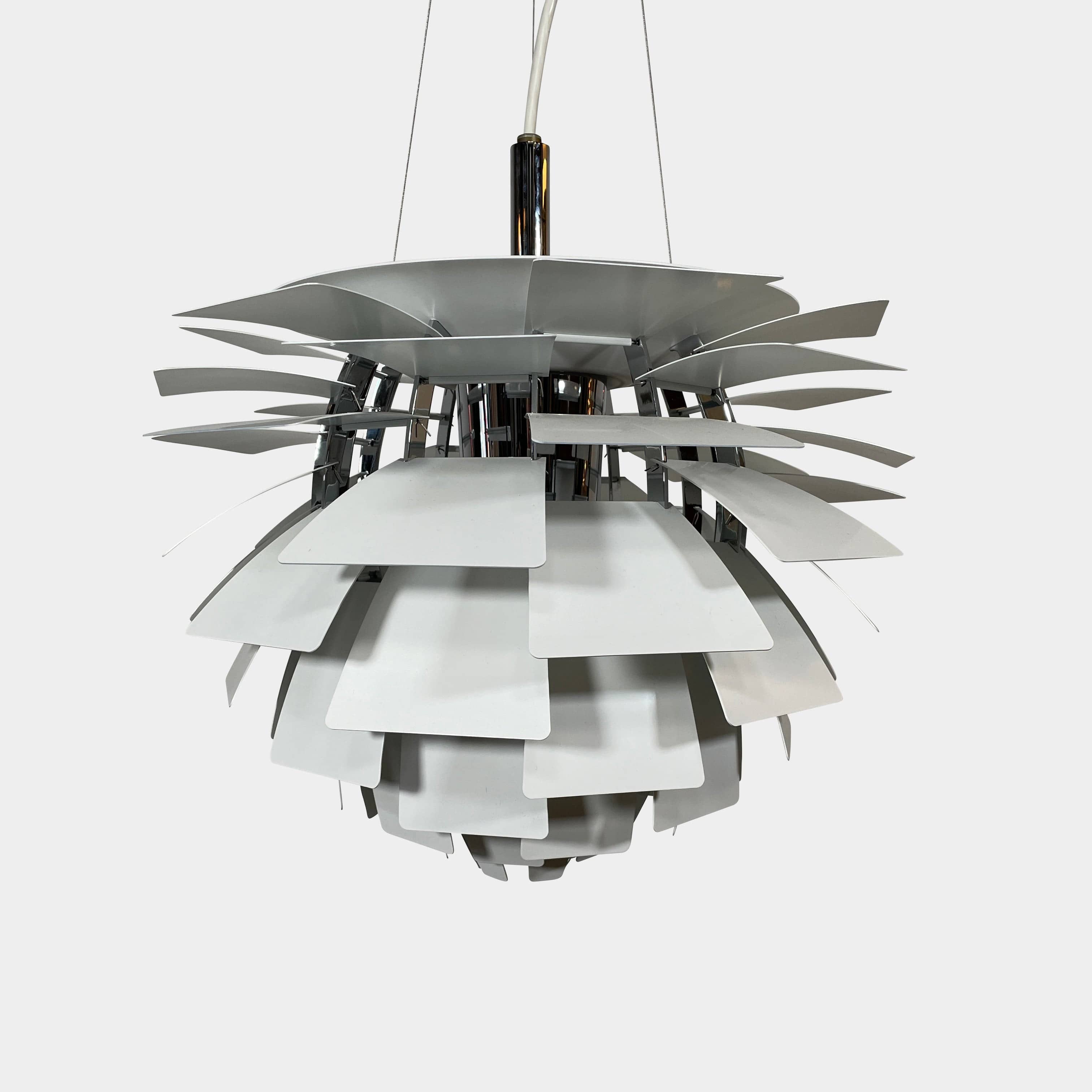 A Louis Poulsen PH Artichoke Suspension light with a white shade, providing glare-free light.