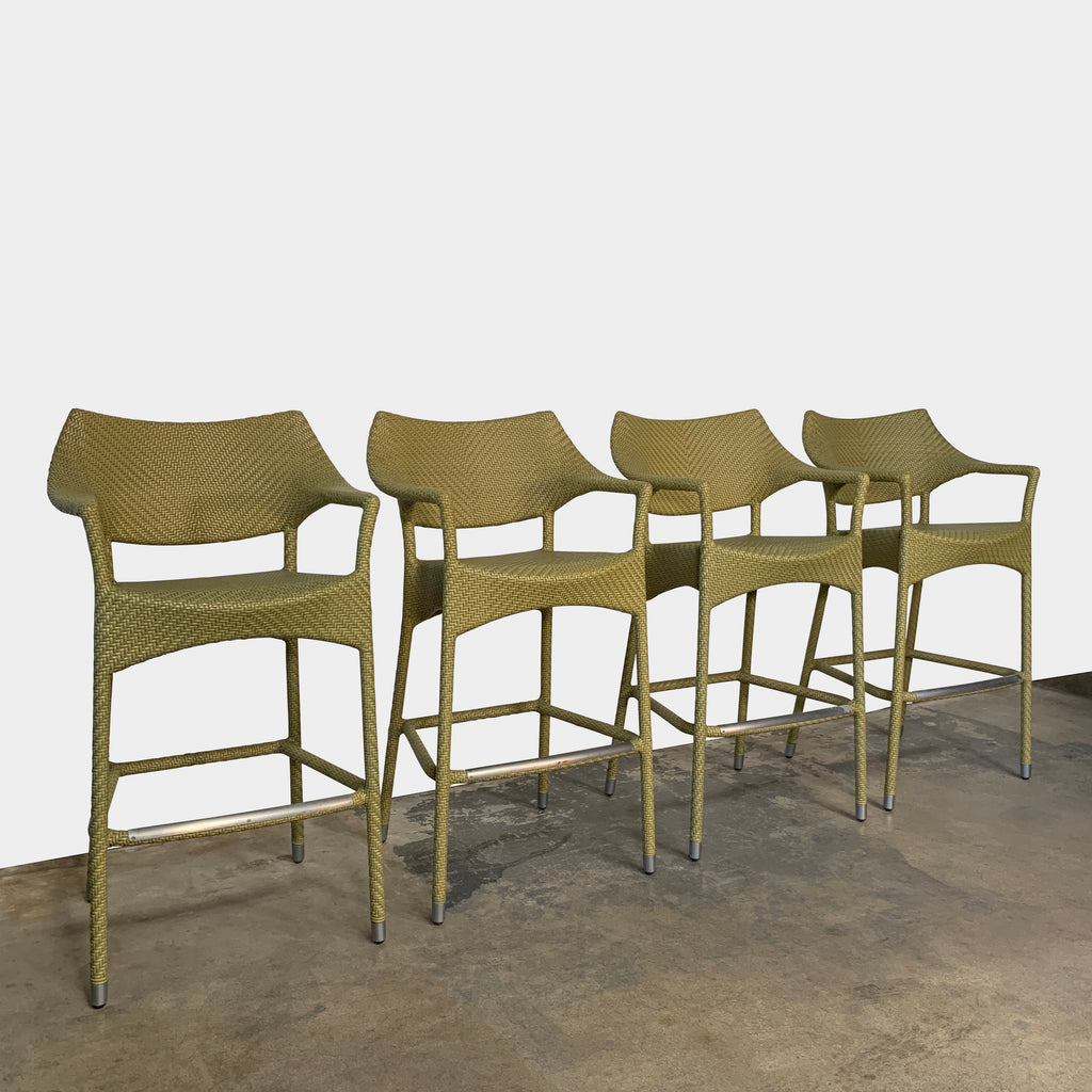 A Janus et Cie Amari Outdoor Bar Height Stool Set, made of green rattan, is showcased against a white background.