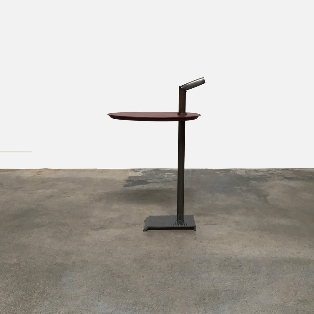 A unique side table, the Bip Bip Leather & Bronze Side Table by Promemoria, with a metal base and a burgundy top.