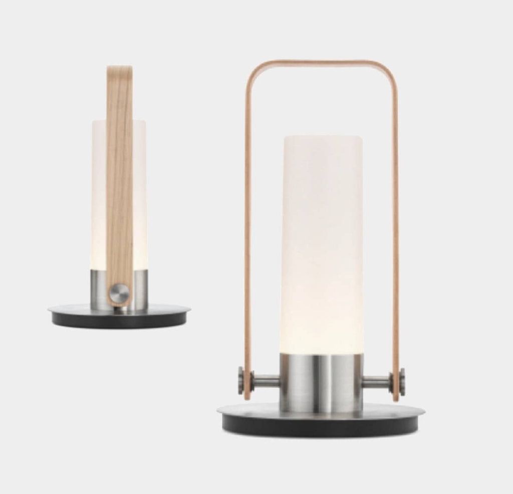 A Luna Lantern Portable Light with a wooden base and a glass cylinder.