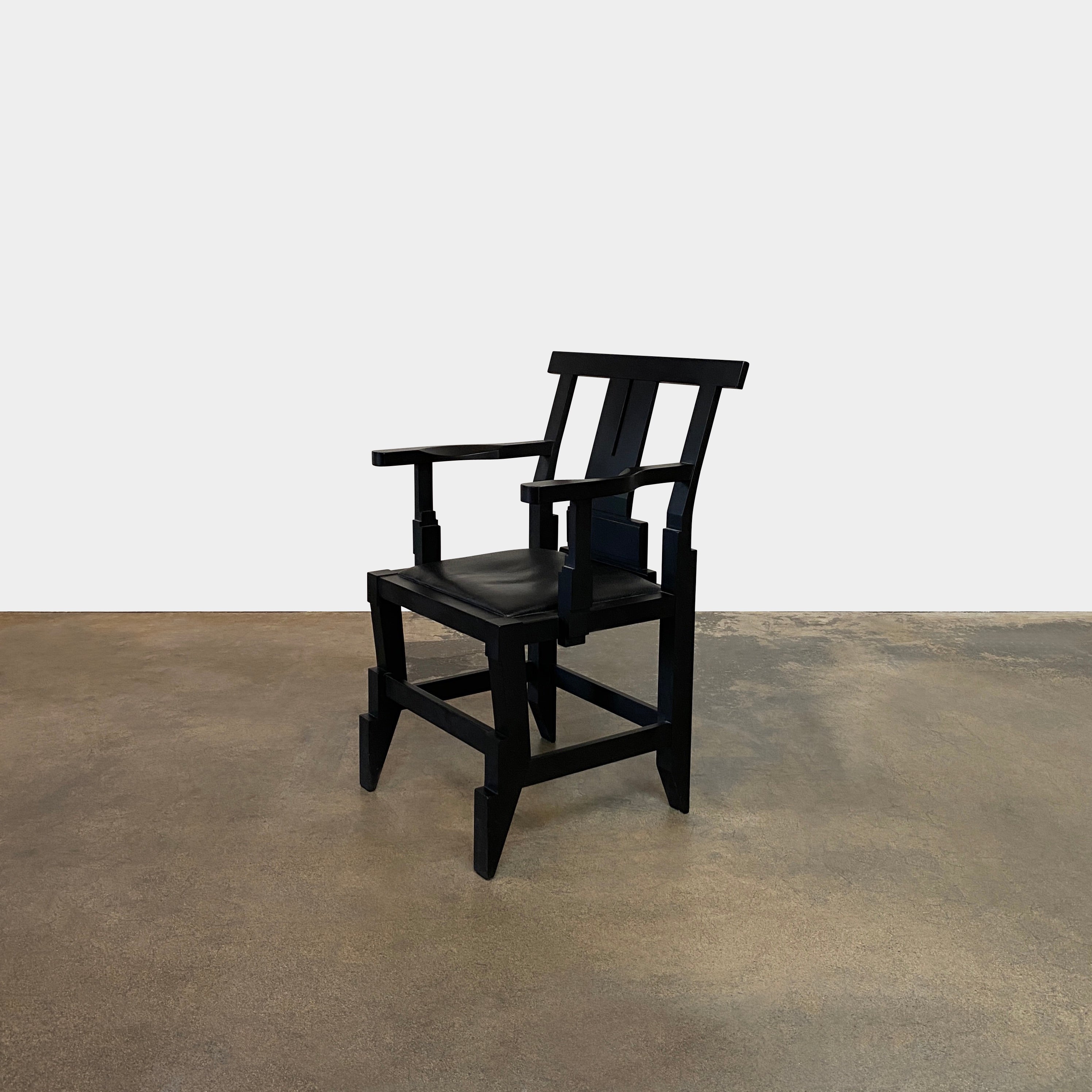 A rare vintage Solitar armchair by John Kandell, crafted in black wood, showcases an angular, geometric design that evokes the Memphis Design movement, displayed against a plain background.