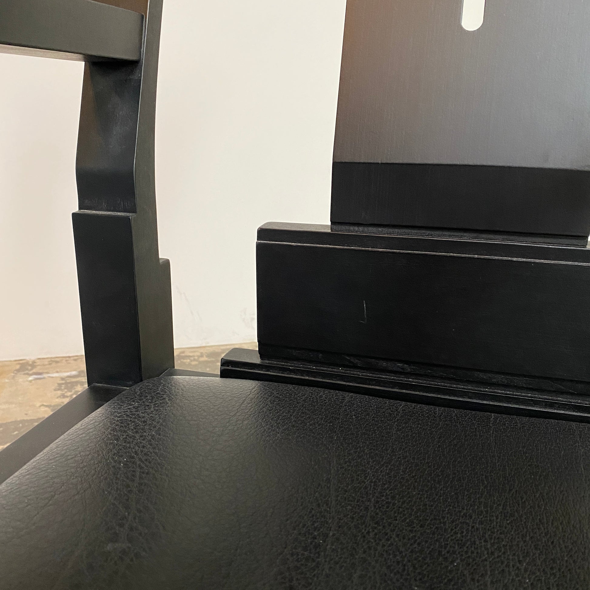 A rare vintage Solitar armchair by John Kandell, crafted in black wood, showcases an angular, geometric design that evokes the Memphis Design movement, displayed against a plain background.