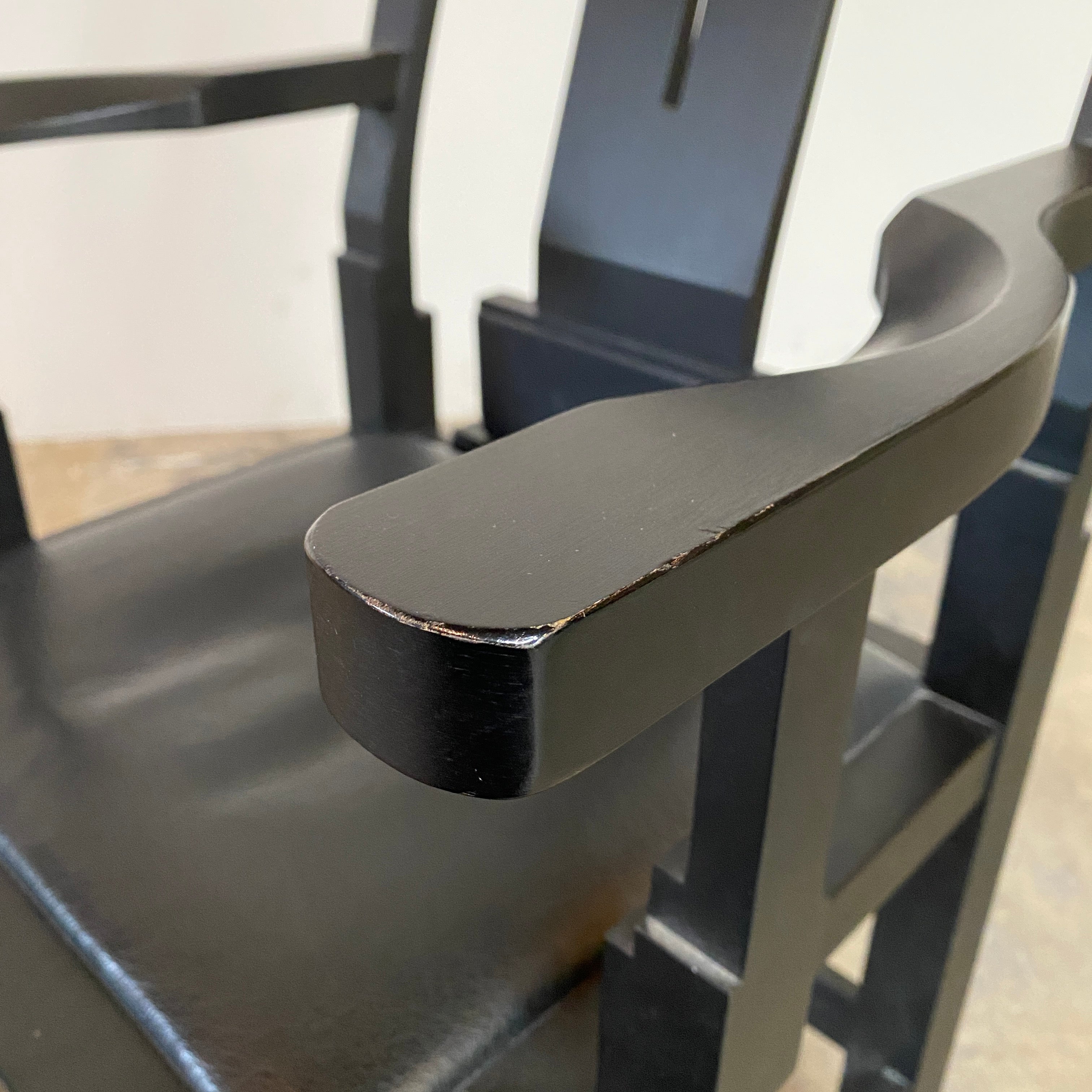 A rare vintage Solitar armchair by John Kandell, crafted in black wood, showcases an angular, geometric design that evokes the Memphis Design movement, displayed against a plain background.