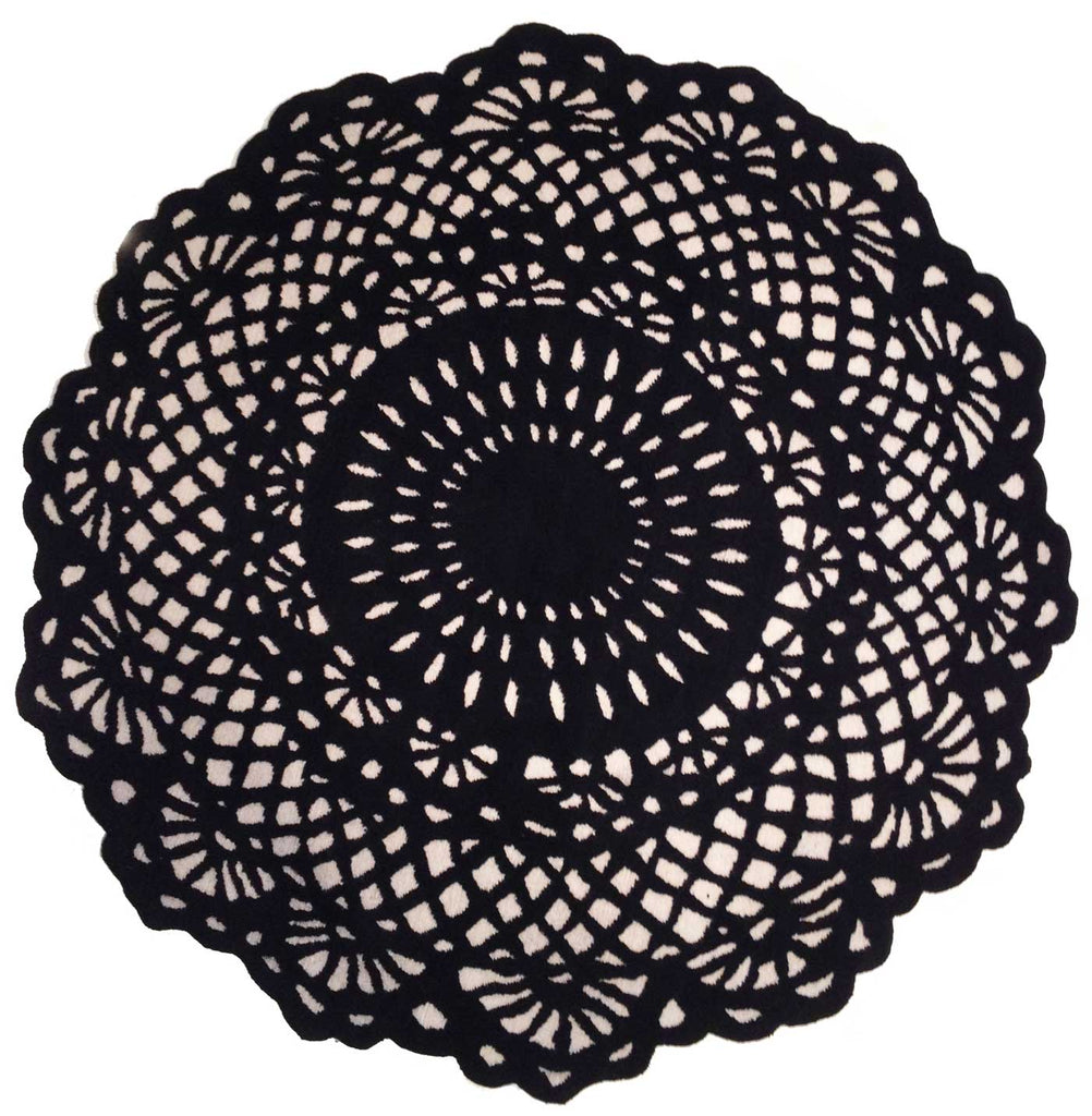 A Delinear Doily 6' Round Black and Cream Rug made of Himalayan wool, delicately delinear, placed on a white surface.